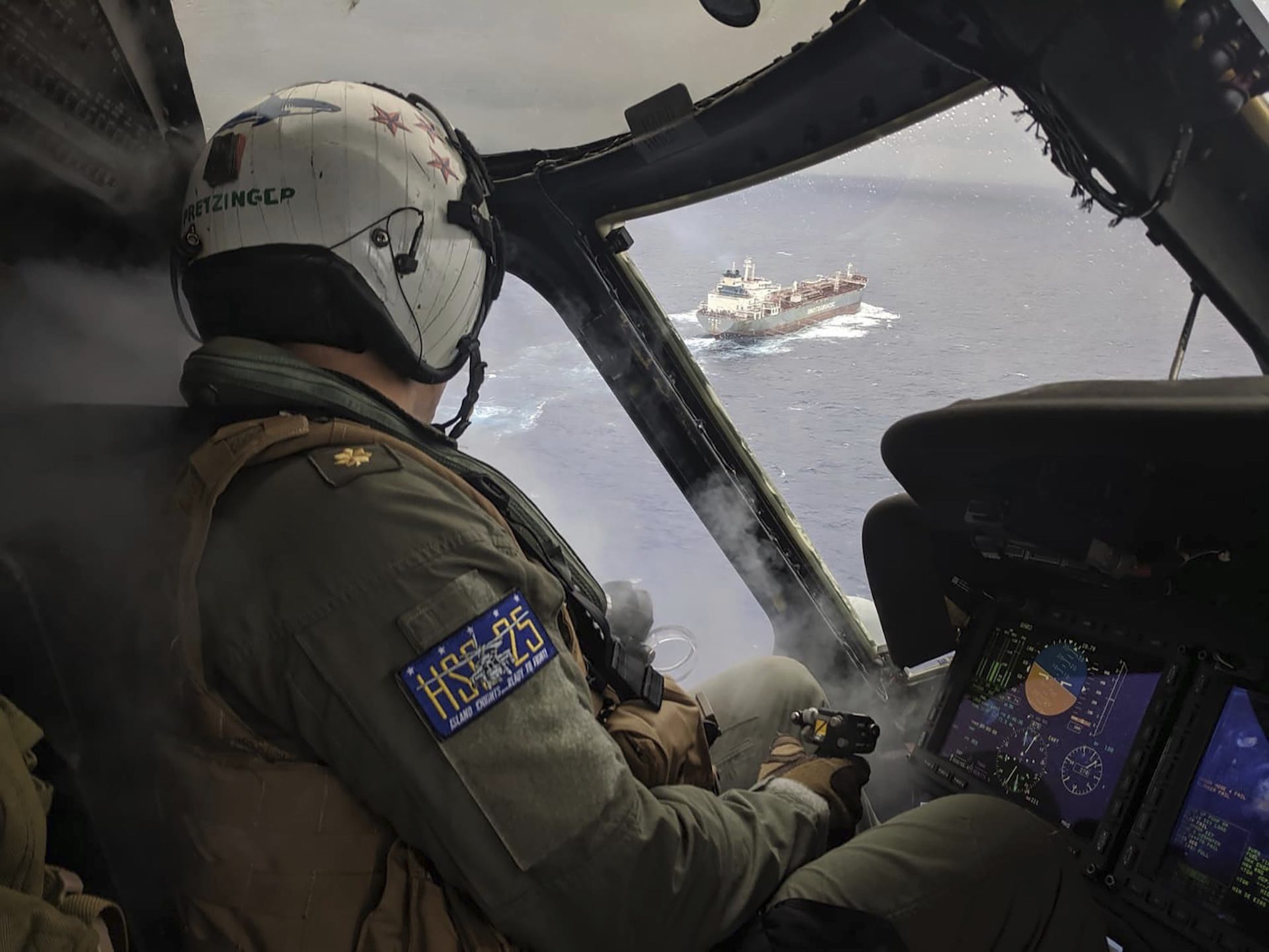 This photo provided by the U.S. Navy on Aug. 6, 2019, Lt. Cmdr. Philip Pretzinger, from Dayton, Ohio, approaches the civilian oil tanker CSC Brave during a medical evacuation mission by the "Island Knights" of Helicopter Sea Combat Squadron (HSC) 25. HSC-25 provides a multi-mission rotary wing capability for units in the U.S. 7th Fleet area of operations and maintains a Guam-based 24-hour search and rescue and medical evacuation capability.