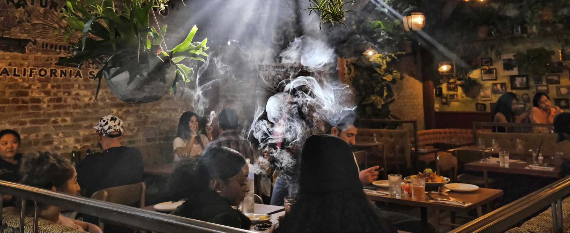 This Nov. 13, 2019 file photo shows patrons smoking marijuana at Lowell's Original Cannabis Cafe, a legal marijuana establishment, in Los Angeles.