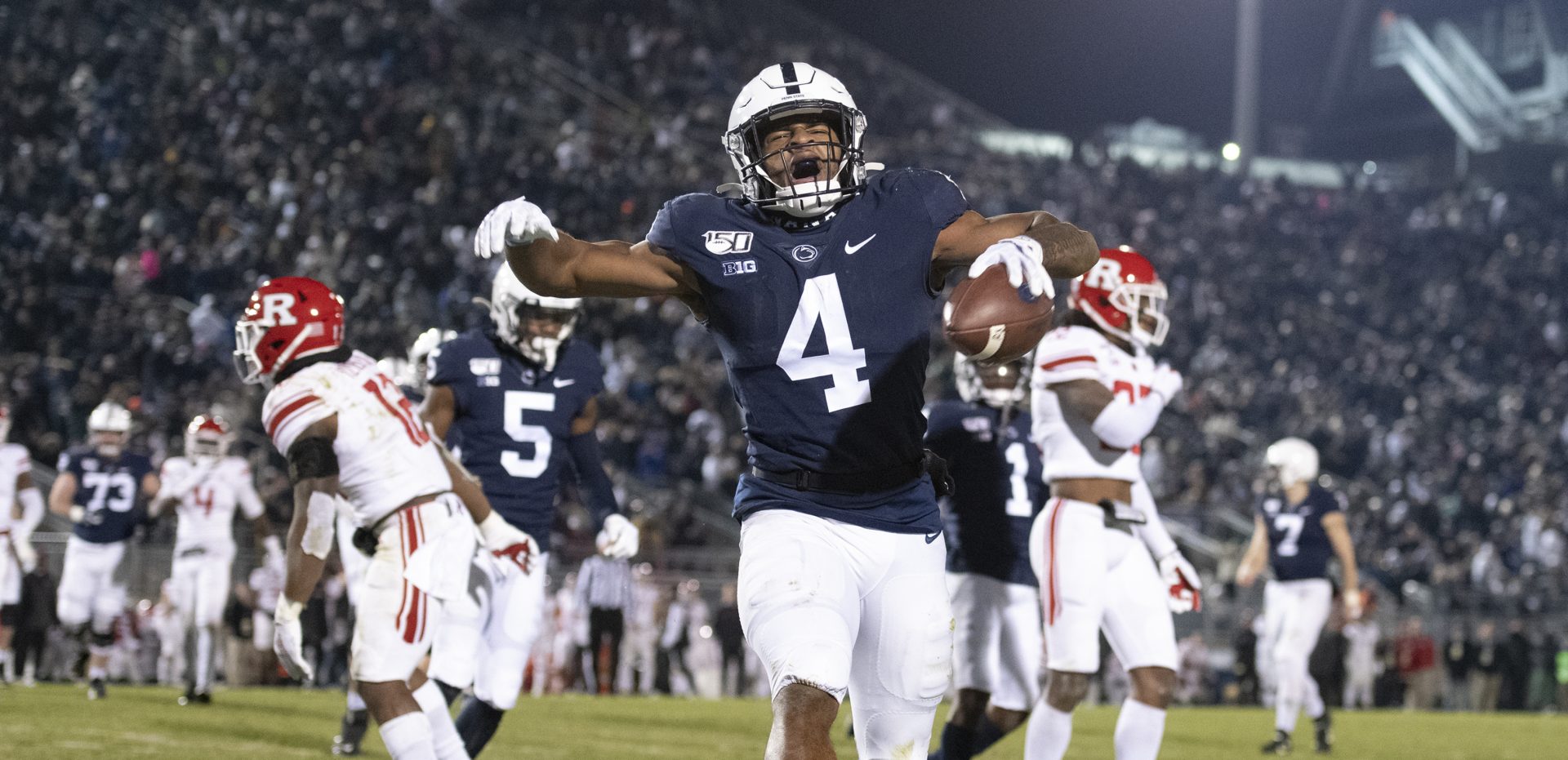 Penn State running back Journey Brown (4) celebrates his third quarter touchdown run against Rutgers during an NCAA college football game in State College, Pa., on Saturday, Nov. 30, 2019. Penn State defeated Rutgers 27-6. (AP Photo/Barry Reeger)