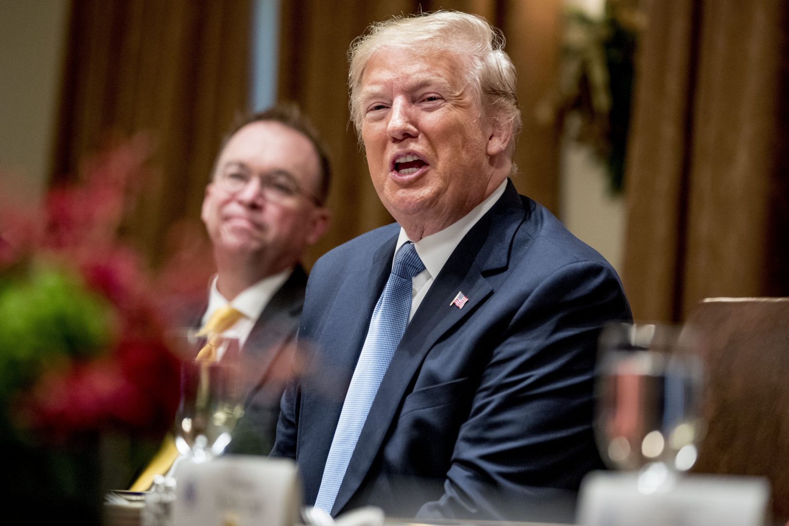 President Donald Trump, foreground, accompanied by acting chief of staff Mick Mulvaney, left, speaks at a luncheon with members of the United Nations Security Council in the Cabinet Room at the White House in Washington, Thursday, Dec. 5, 2019. (AP Photo/Andrew Harnik)