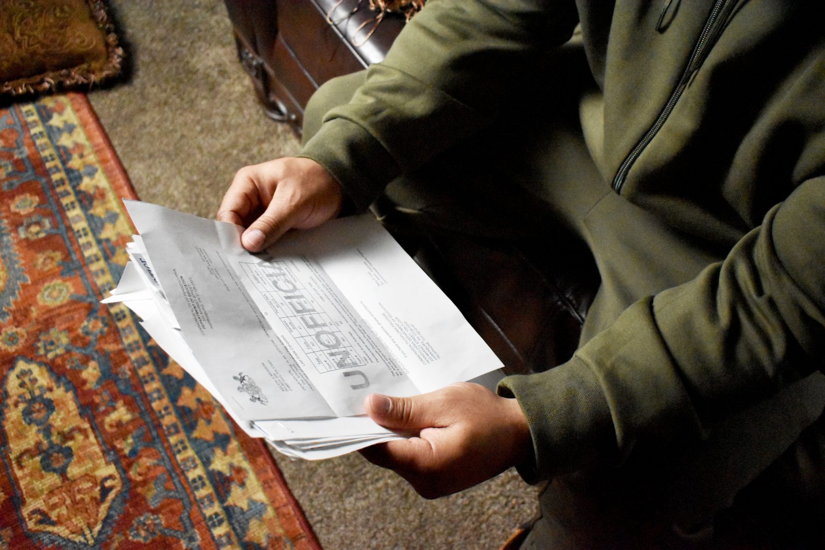 Kevin Maxson, a former inmate at Dauphin County Prison, goes through his letters and bills from his time locked up. A PA Post investigation found that six counties charged close to $15 million in fees to prisoners.  (Joseph Darius Jaafari/PA Post). 
