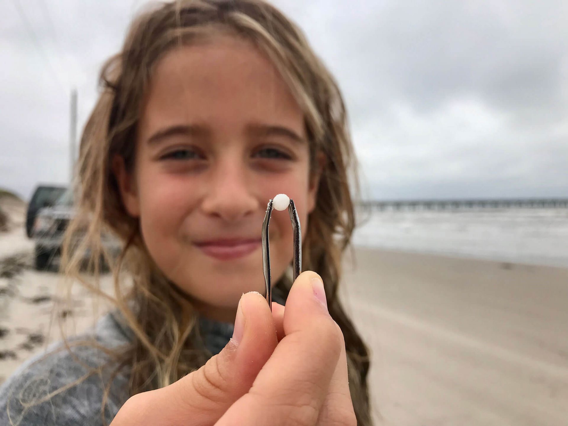 Nurdle Patrol participant Parker Tunnell holds a nurdle she found in Texas. The Ohio Valley will be home to Shell’s ethane cracker, which will produce trillions of pellets annually. (Photo courtesy of Jace Tunnell)