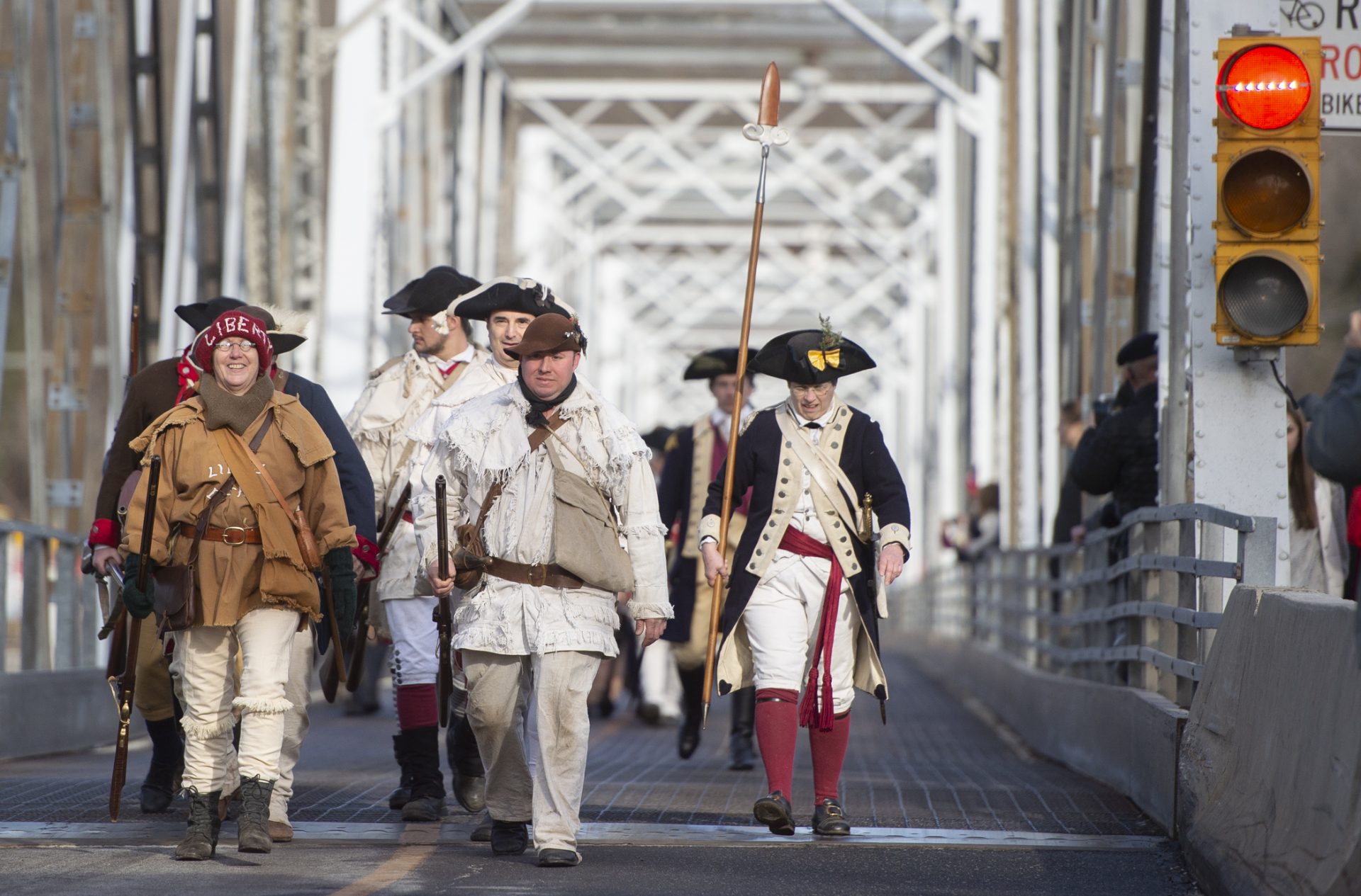 After crossing the Delaware River, troops march across the bridge at Washington's Crossing that connects New Jersey and Pennsylvania.