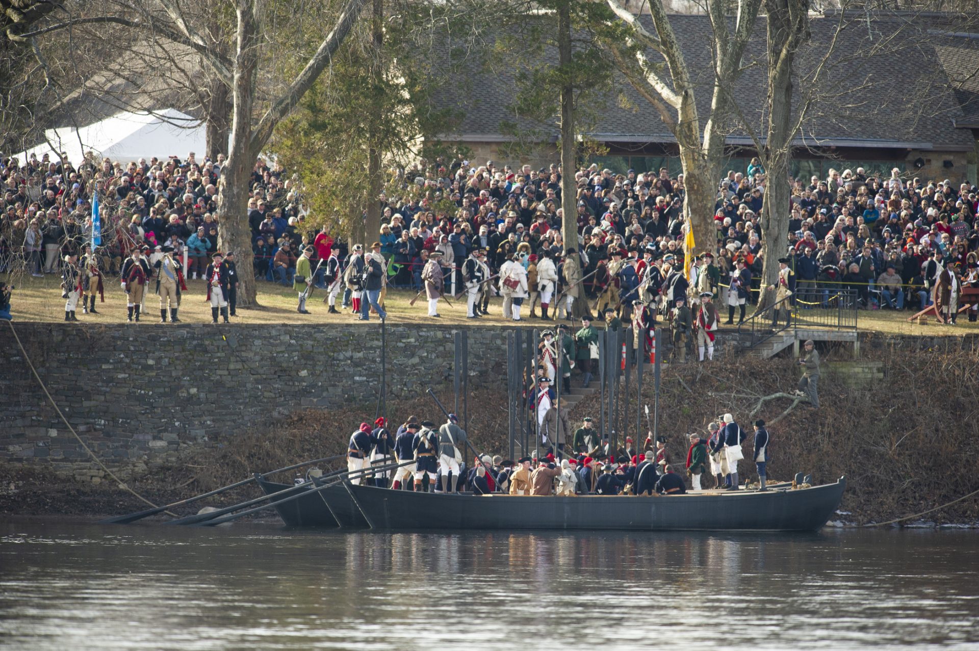 Reenactors board replicas of the Durham boats that originally carried Washington and his soldiers across the Delaware River.