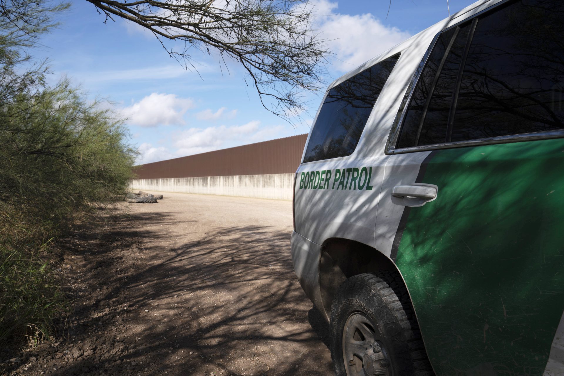 A Border Patrol vehicle is parked near the existing border wall south of Donna, Texas.