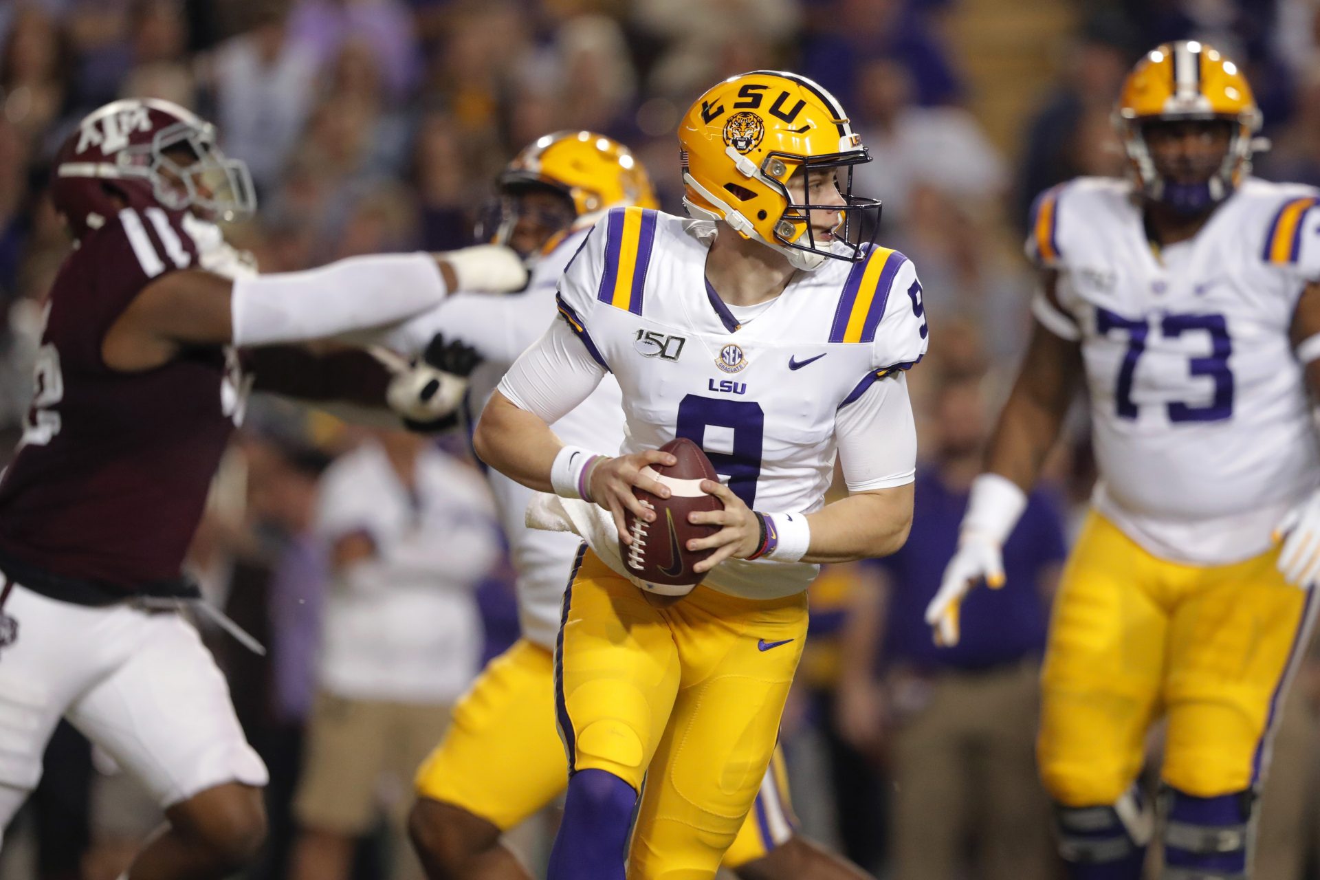 LSU quarterback Joe Burrow (9) looks for a receiver during the first half of the team's NCAA college football game against Texas A&M in Baton Rouge, La., Saturday, Nov. 30, 2019.