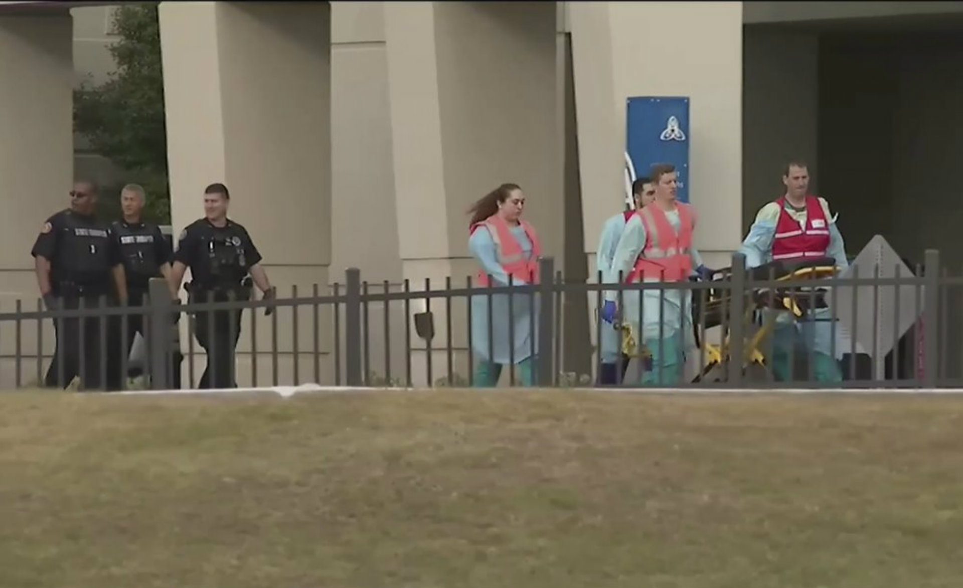 This photo taken from video provided by WEAR-TV shows emergency responders near the Naval Air Base Station in Pensacola, Fla., Friday, Dec. 6, 2019. The US Navy is confirming that an active shooter and one other person are dead after gunfire at the Naval Air Station in Pensacola. Area hospital representatives tell The Associated Press that at least 11 people were hospitalized. The base remains locked down amid a huge law enforcement response.