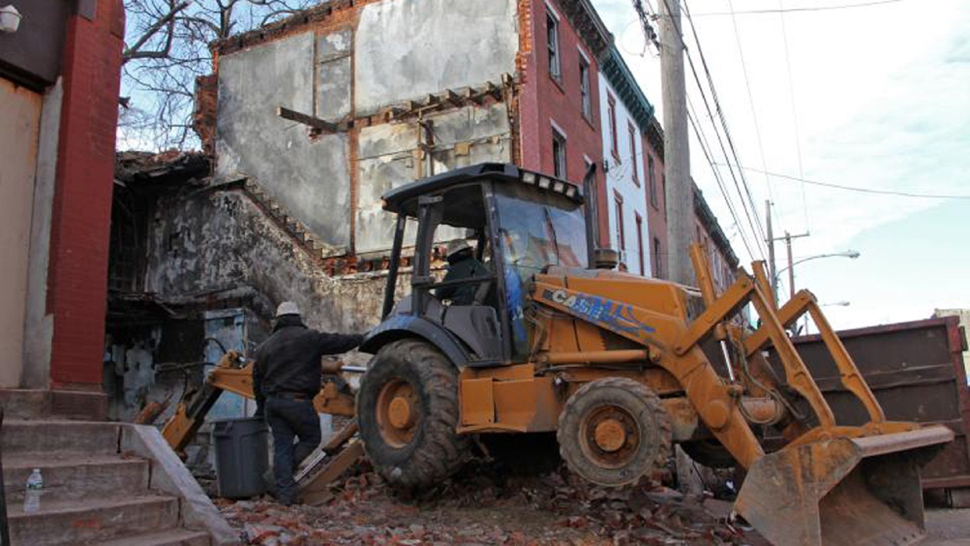 Workers demolish a North Philadelphia rowhouse. 