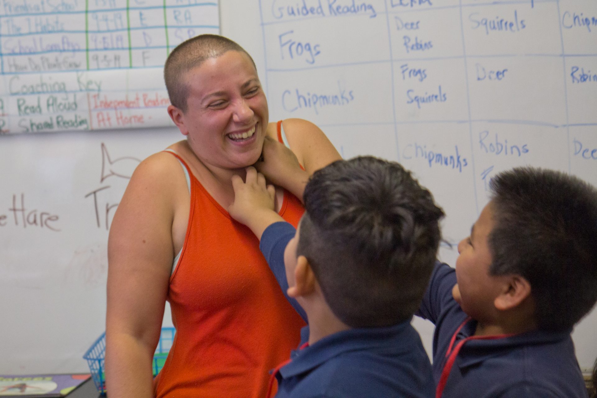 Isy Abraham-Raveson consents to being tickled in the neck by two 3rd graders at the Yes to Consent workshop at the Puentes De Salud after school program.