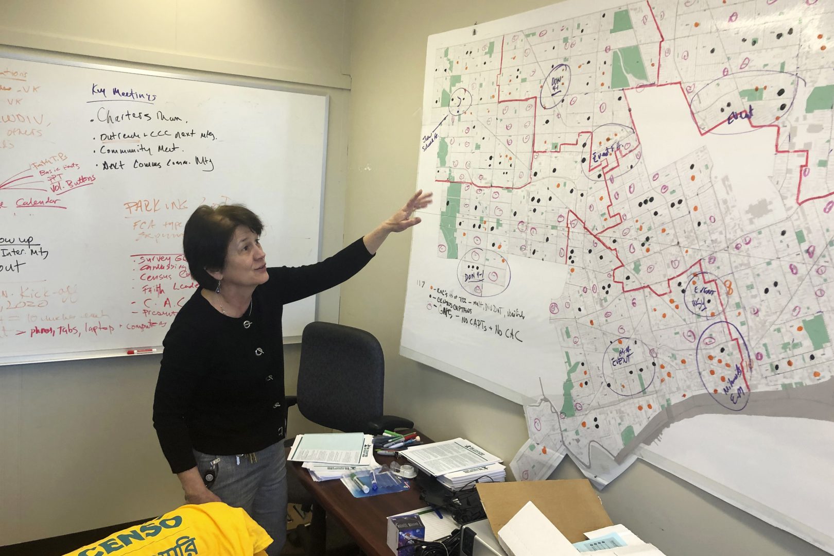 In this Nov. 22, 2019, photo, Detroit 2020 Census Campaign executive director Victoria Kovari looks over a Detroit map showing city neighborhoods that were under-counted in the 2010 census. In 2010, 220,000 Detroit residents were living in households that did not fill out questionnaires, costing the city $2,000 to $5,000 annually for every uncounted person, said Kovari. (