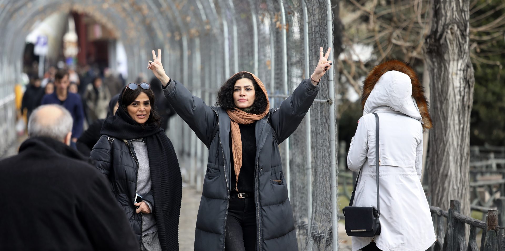 A woman reacts  while walking in Tajrish square in northern Tehran, Iran, Thursday, Jan. 9, 2020. Many Iranians say they are relieved that neither their country nor the United States appear primed right now for a more direct military confrontation that could lead to war.