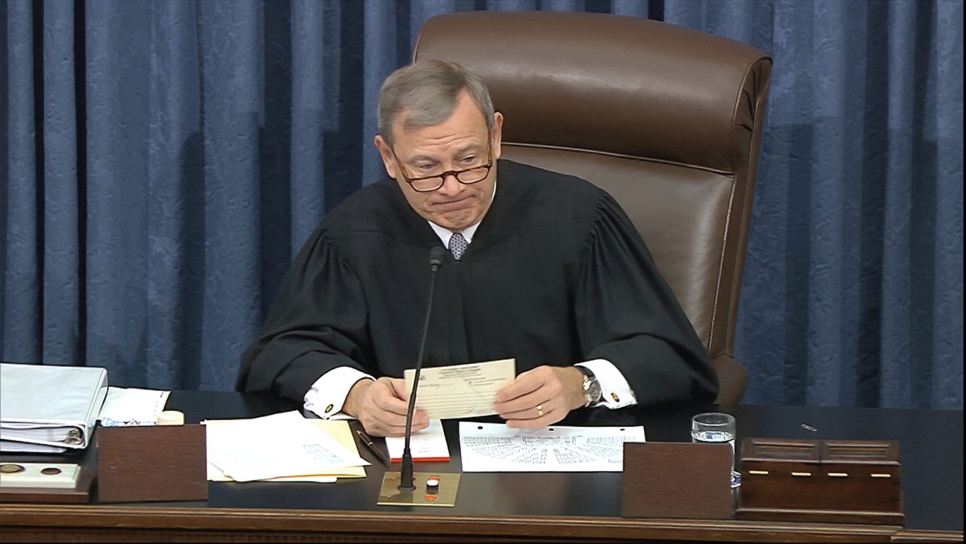 In this image from video, presiding officer Chief Justice of the United States John Roberts reads a question during the impeachment trial against President Donald Trump in the Senate at the U.S. Capitol in Washington, Thursday, Jan. 30 2020.