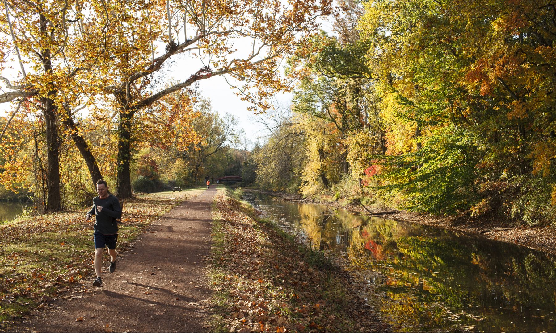 In this Saturday, Oct. 24, 2015, photo, a man runs along the canal path in Delaware Canal State Park at Washington Crossing, Pa. The canal path, the central feature of the Delaware Canal State Park, runs 60 miles parallel to the Delaware River in southeastern Pennsylvania.