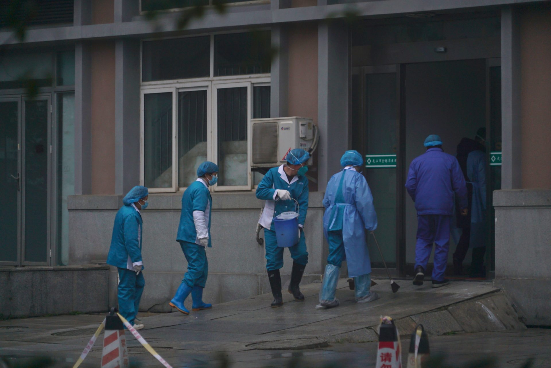 Hospital staff wash the emergency entrance of Wuhan Medical Treatment Center, where some infected with a new virus are being treated, in Wuhan, China, Wednesday, Jan. 22, 2020. The number of cases of a new coronavirus from Wuhan has risen to over 400 in China health authorities said Wednesday.