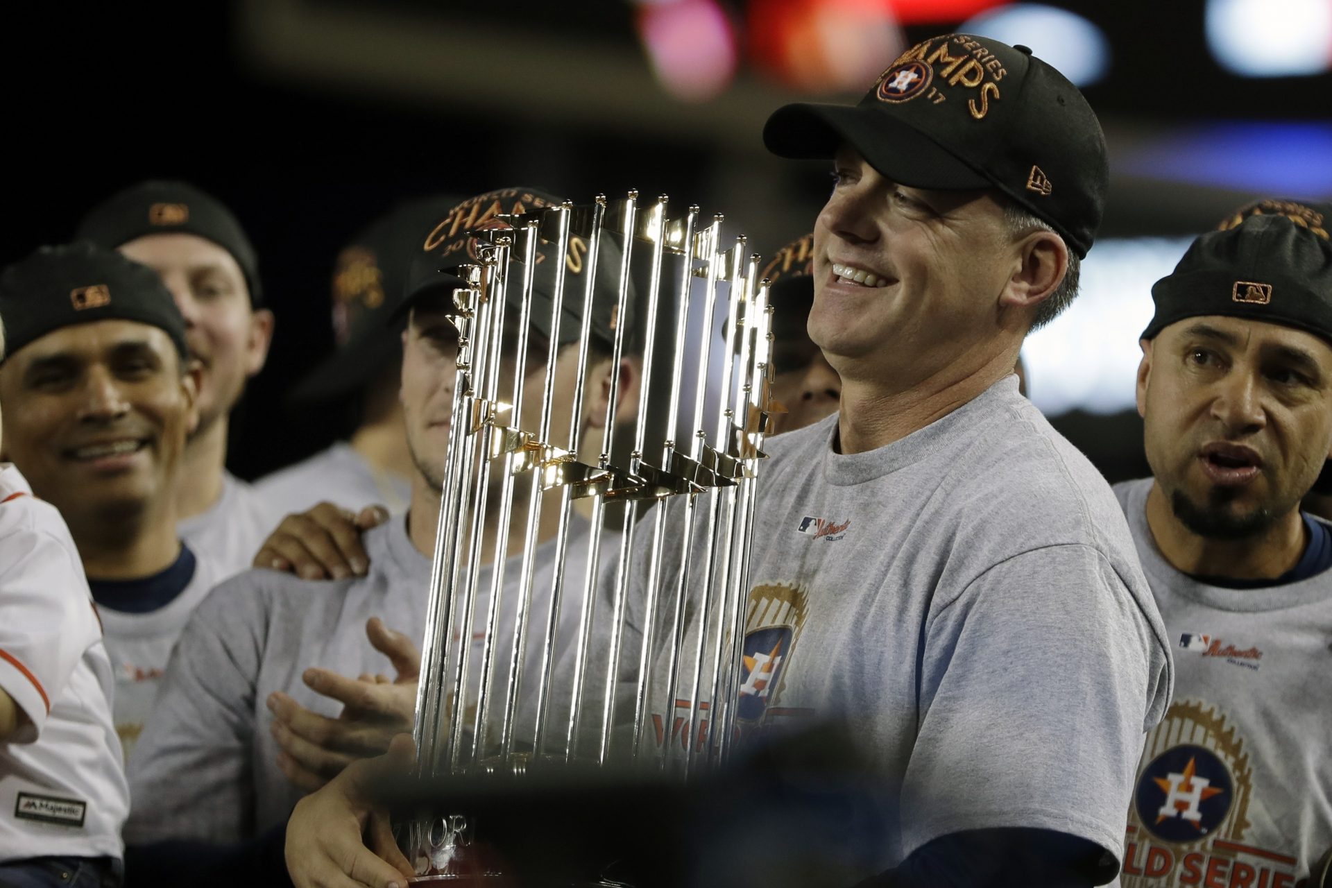 FILE - In this Nov. 1, 2017, file photo, Houston Astros manager A.J. Hinch holds the championship trophy after Game 7 of baseball's World Series against the Los Angeles Dodgers, in Los Angeles. Houston manager AJ Hinch and general manager Jeff Luhnow were suspended for the entire season Monday, Jan. 13, 2020, and the team was fined $5 million for sign-stealing by the team in 2017 and 2018 season. Commissioner Rob Manfred announced the discipline and strongly hinted that current Boston manager Alex Cora — the Astros bench coach in 2017 — will face punishment later. Manfred said Cora developed the sign-stealing system used by the Astros.
