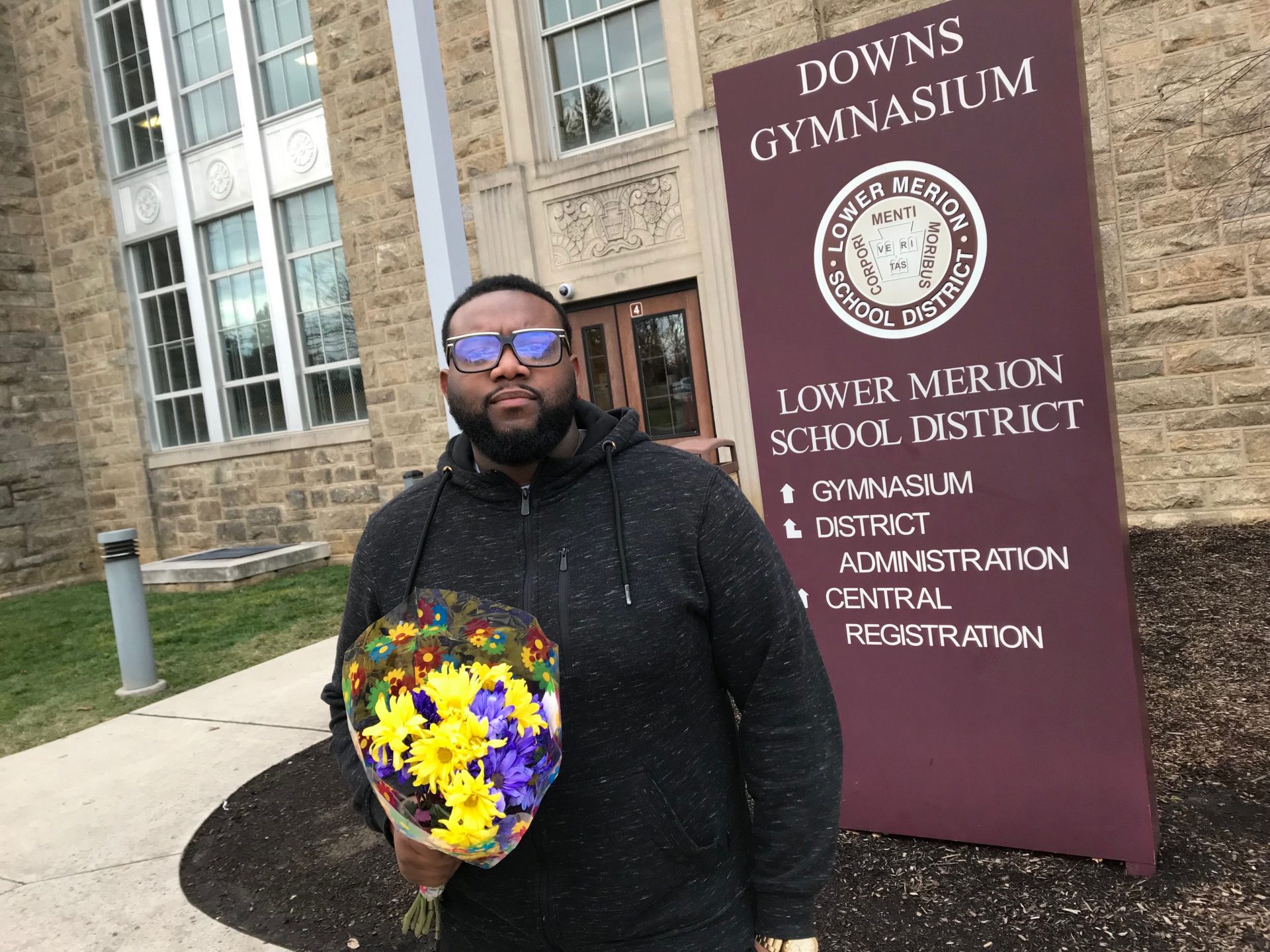 Romeire Brown, of Wynnewood, brought a bouquet of flowers to Lower Merion High School where he gathered to pay his respects to alumnus Kobe Bryant.