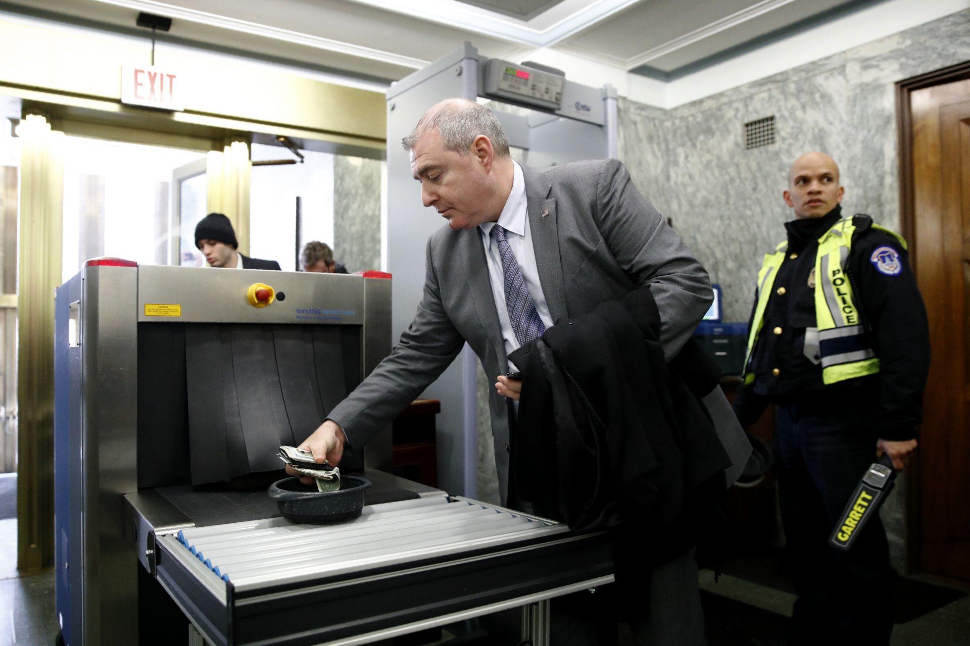 Lev Parnas, a Rudy Giuliani associate with ties to Ukraine, collects his belongings after going through a security checkpoint during the impeachment trial of President Trump on Wednesday.
