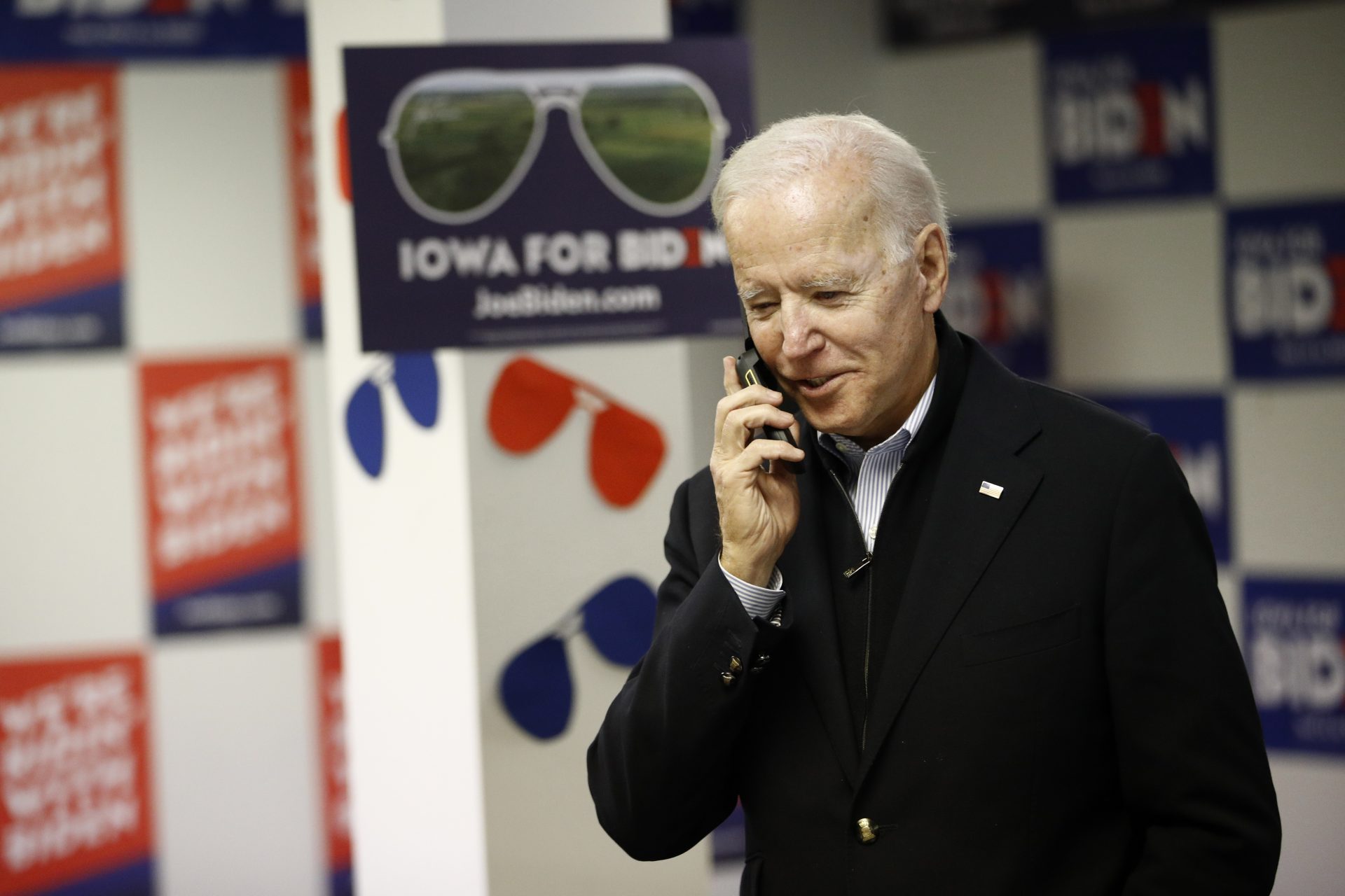 Democratic presidential candidate former Vice President Joe Biden speaks with a potential caucus-goer during a stop at a campaign field office, Monday, Jan. 13, 2020, in Des Moines, Iowa.