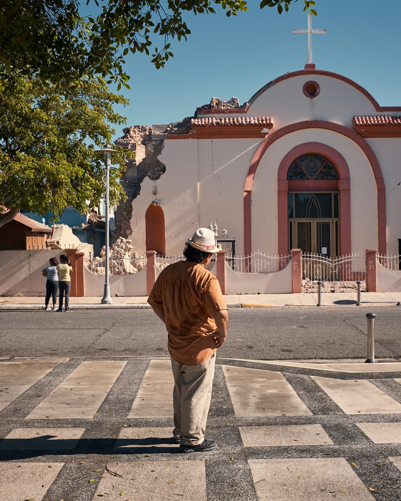 A man stands in front of a church that was damaged in an earthquake on Monday in Guayanilla, Puerto Rico.