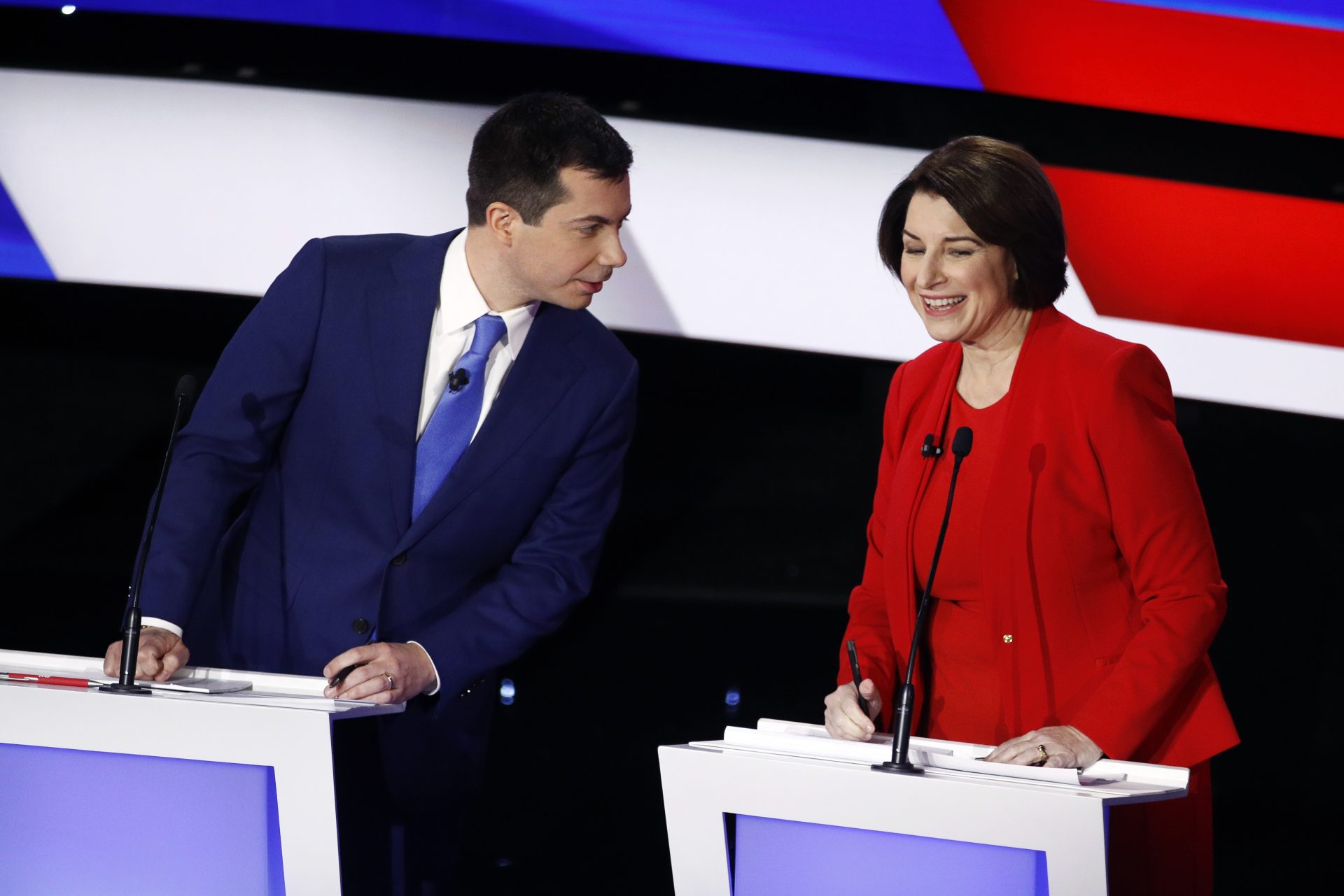 Democratic presidential candidates former South Bend Mayor Pete Buttigieg, left, and Sen. Amy Klobuchar, D-Minn., right, talk during a break Tuesday, Jan. 14, 2020, in a Democratic presidential primary debate hosted by CNN and the Des Moines Register in Des Moines, Iowa.