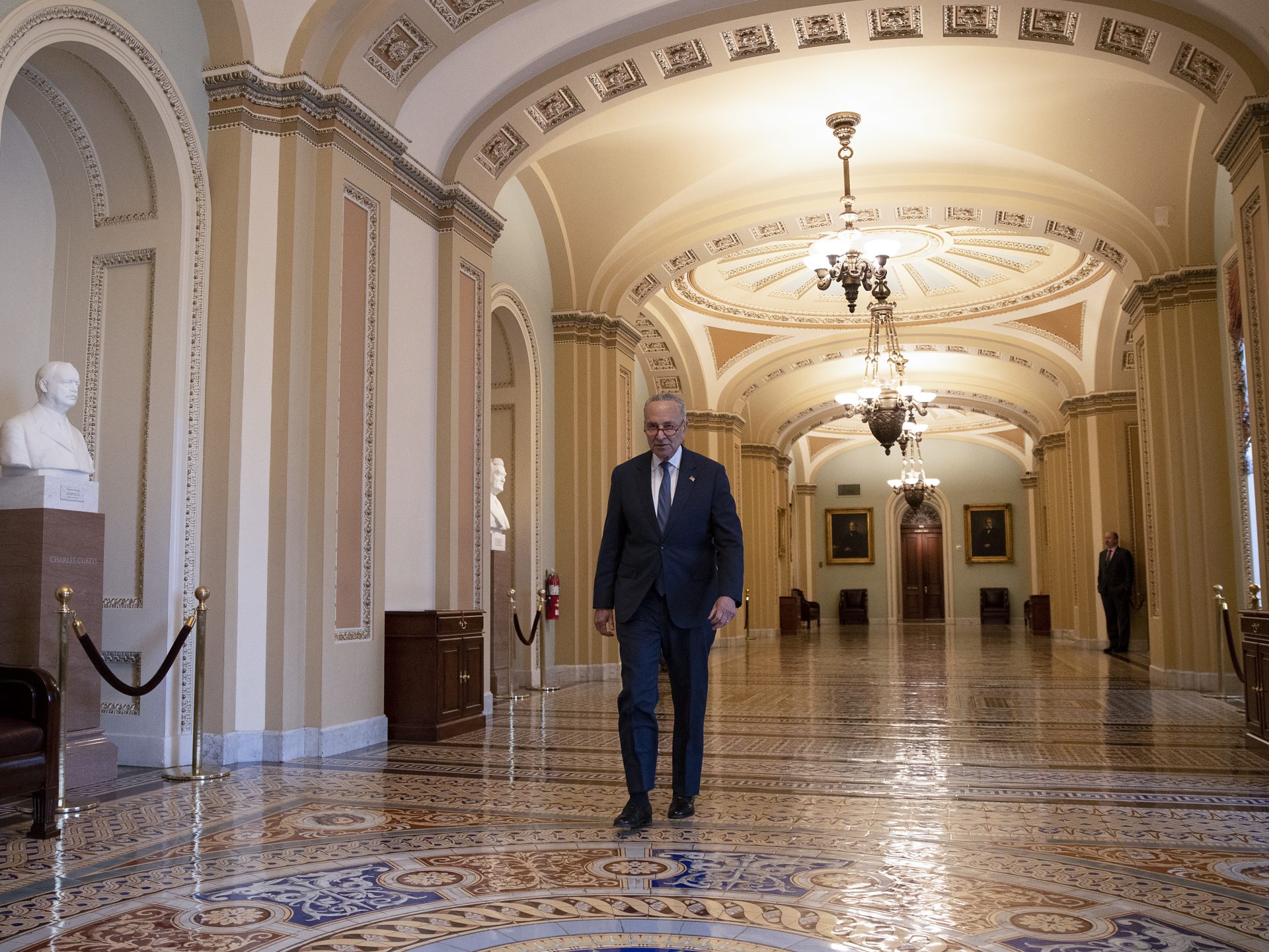 Senate Minority Leader Chuck Schumer, D-N.Y., walks from the Senate chamber at the U.S. Capitol on Friday.