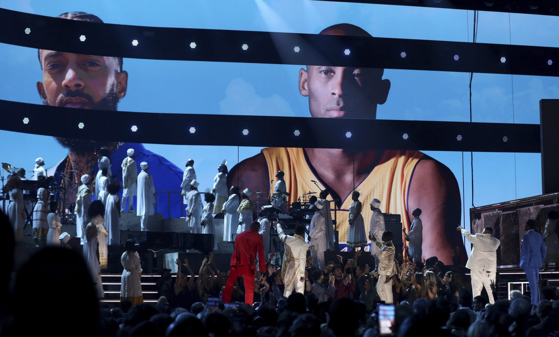 YG, from left, John Legend, Kirk Franklin, DJ Khaled and Meek Mill point to a screen showing Nipsey Hussle and Kobe Bryant during a tribute at the 62nd annual Grammy Awards on Sunday, Jan. 26, 2020, in Los Angeles.