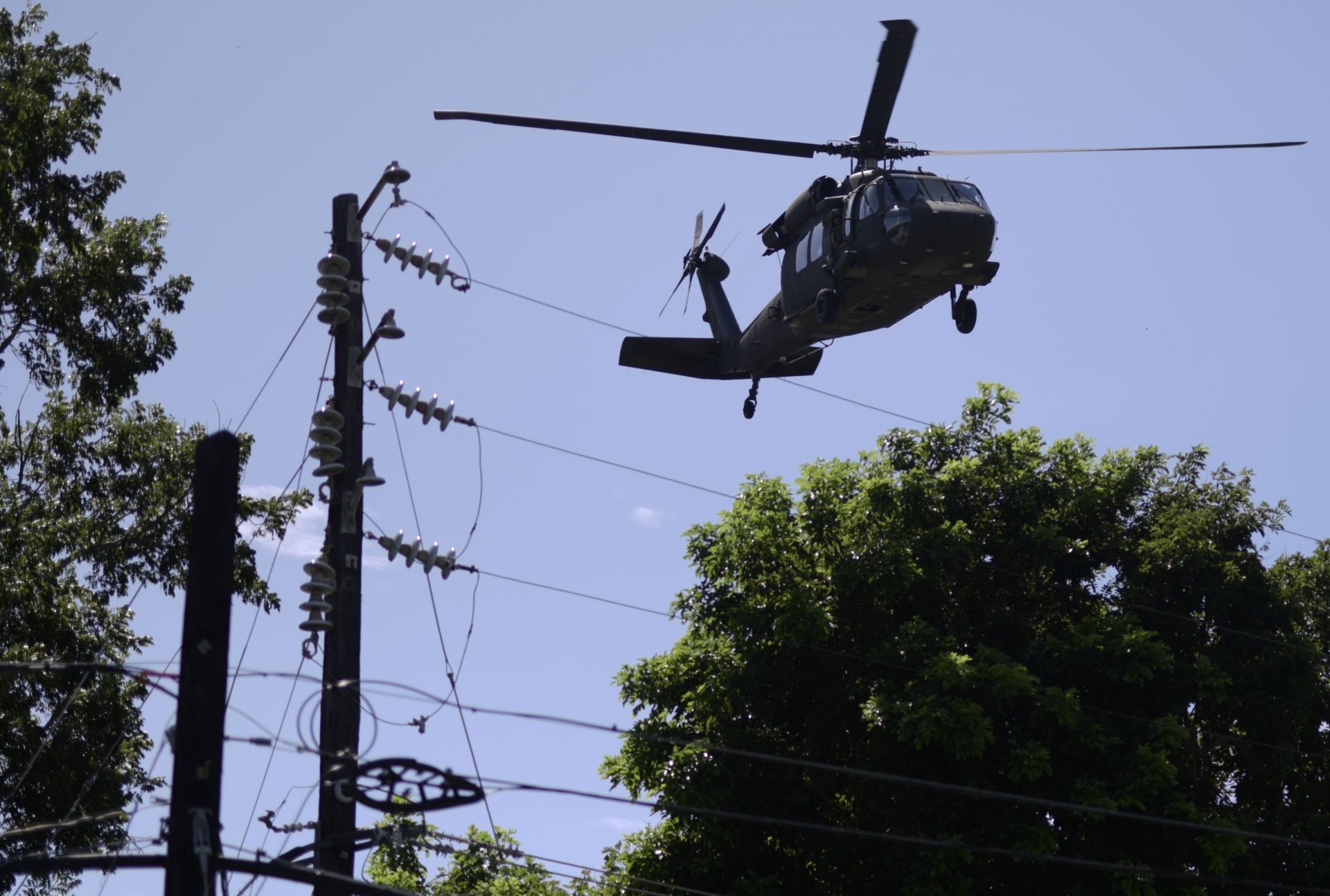 A US military helicopter takes off while US army reserves sets up tents for portable showers at a tent city for hundreds of people displaced by earthquakes in Guanica, Puerto Rico, Tuesday, Jan. 14, 2020. A 6.4 magnitude quake that toppled or damaged hundreds of homes in southwestern Puerto Rico is raising concerns about where displaced families will live, while the island still struggles to rebuild from Hurricane Maria two years ago.