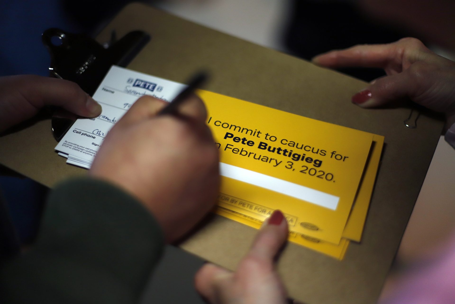 A person signs up to caucus for Democratic presidential candidate former South Bend, Ind., Mayor Pete Buttigieg, following a town hall meeting in Fort Dodge, Iowa, Saturday, Jan. 25, 2020. (AP Photo/Gene J. Puskar) Use Information This content is intended for ed