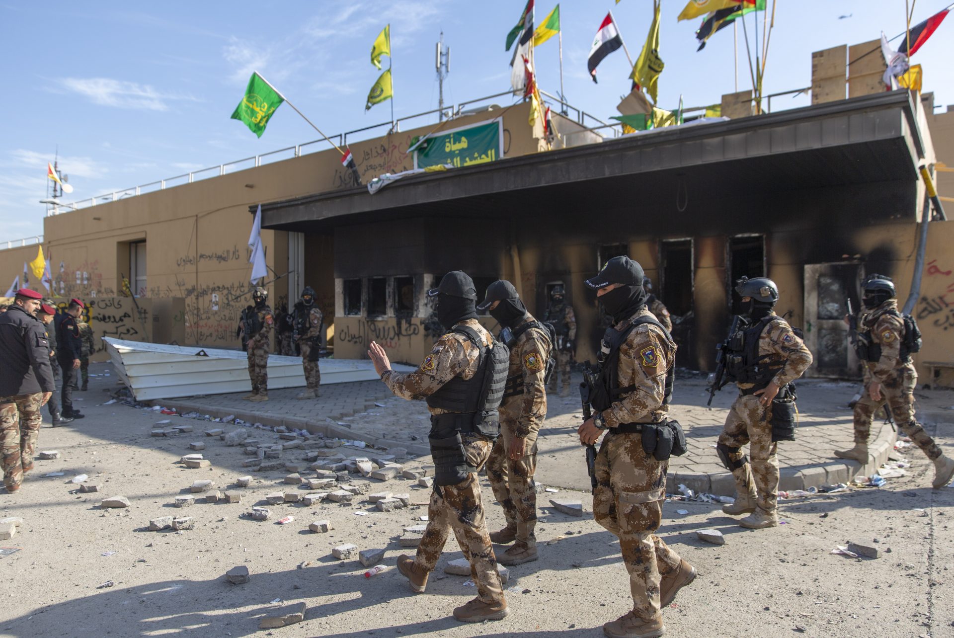 Iraqi army soldiers are deployed in front of the U.S. embassy, in Baghdad, Iraq, Wednesday, Jan. 1, 2020. Iran-backed militiamen have withdrawn from the U.S. Embassy compound in Baghdad after two days of clashes with American security forces.