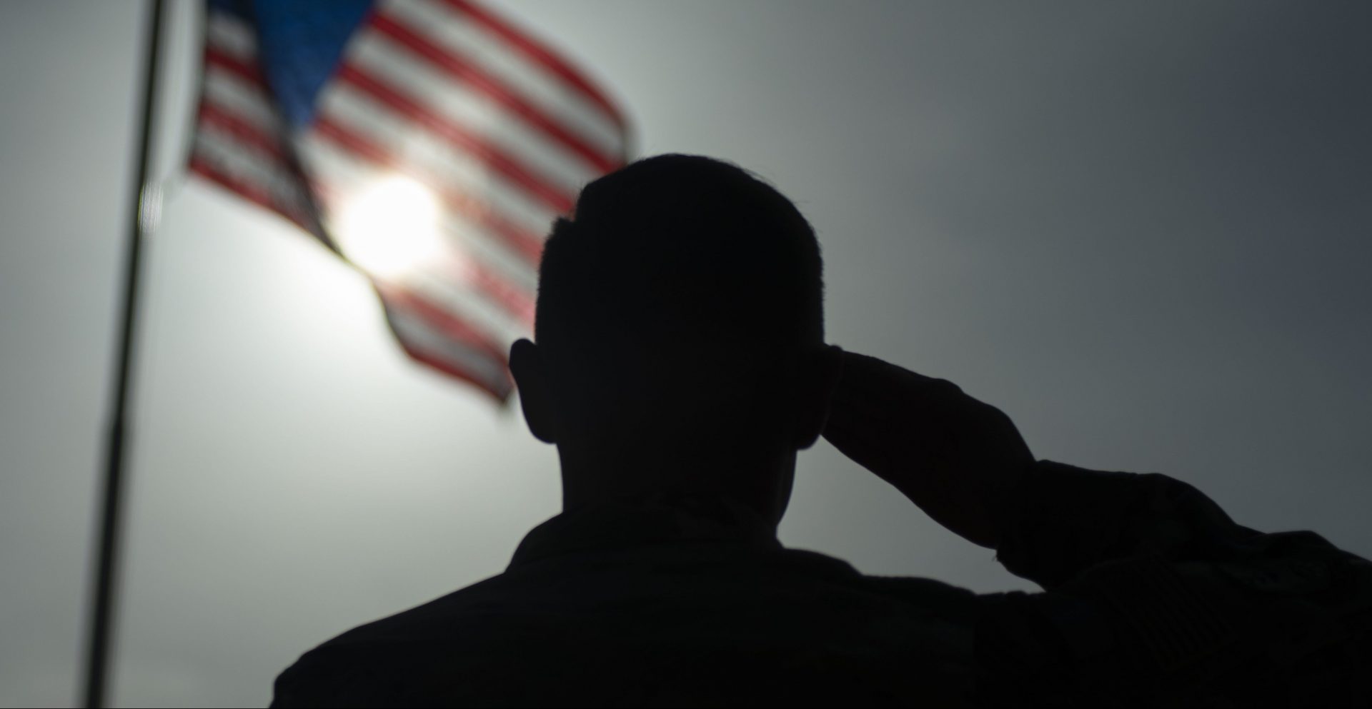 In this photo taken Aug. 26, 2019 and released by the U.S. Air Force, U.S. Air Force Staff Sgt. Devin Boyer, 435th Air Expeditionary Wing photojournalist, salutes the flag during a ceremony signifying the change from tactical to enduring operations at Camp Simba, Manda Bay, Kenya. The al-Shabab extremist group said Sunday, Jan. 5, 2020 that it has attacked the Camp Simba military base used by U.S. and Kenyan troops in coastal Kenya, while Kenya's military says the attempted pre-dawn breach was repulsed and at least four attackers were killed. 