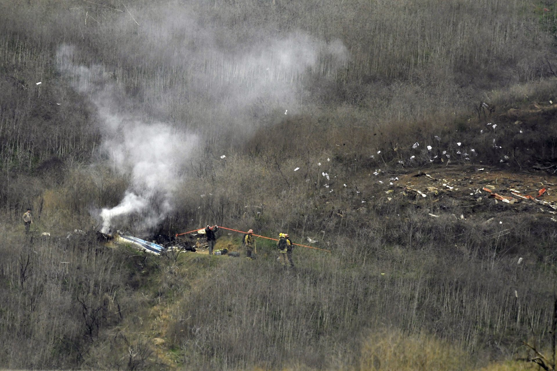 Firefighters work the scene of a helicopter crash Sunday, Jan. 26, 2020, in Calabasas, Calif. NBA basketball legend Kobe Bryant, his teenage daughter Gianna and three others were killed in the crash in Southern California on Sunday.