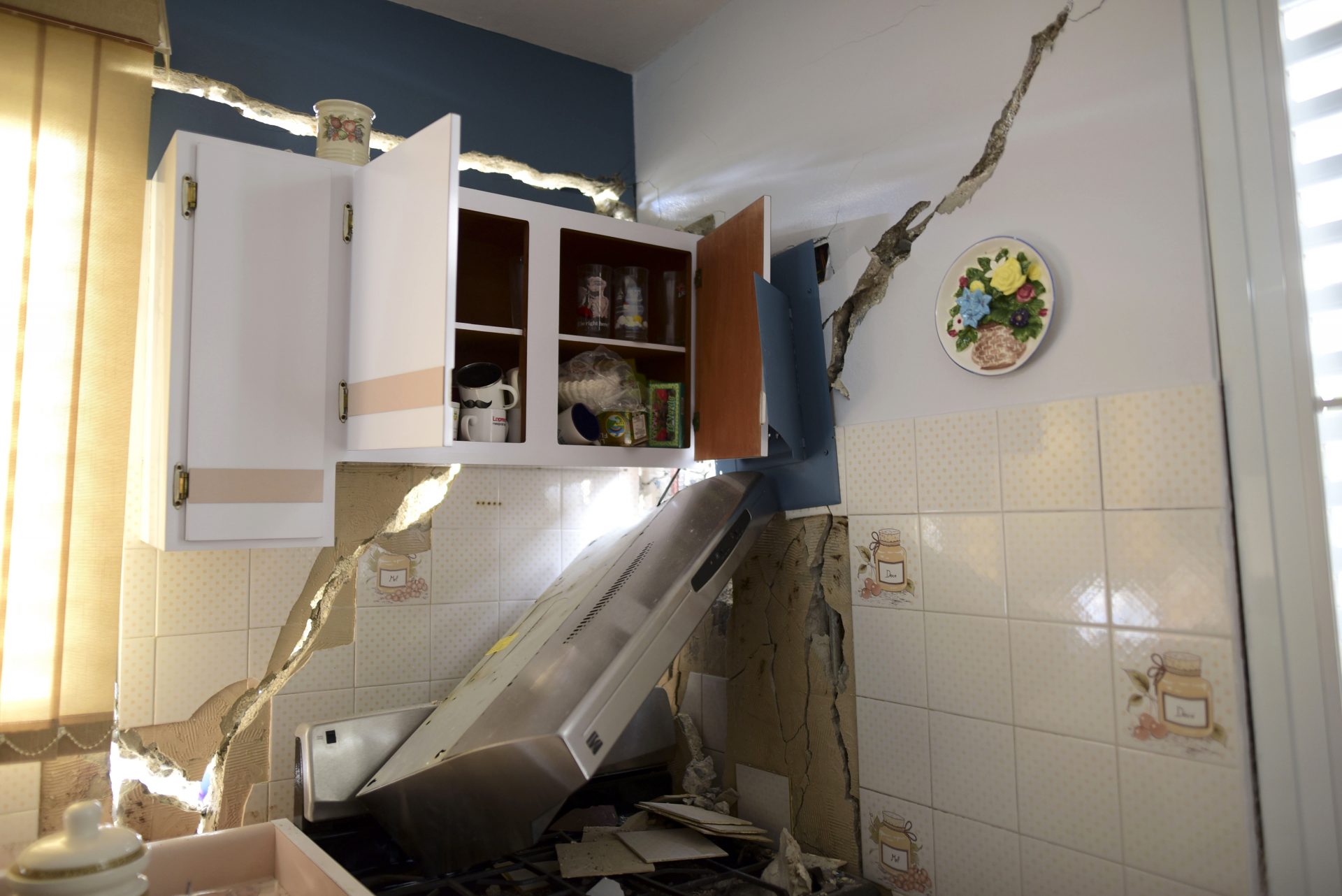 The house of William Mercuchi is damaged after the previous day's magnitude 6.4 earthquake in Yauco, Puerto Rico, Wednesday, Jan. 8, 2020. More than 250,000 Puerto Ricans remained without water on Wednesday and another half a million without power, which also affected telecommunications.