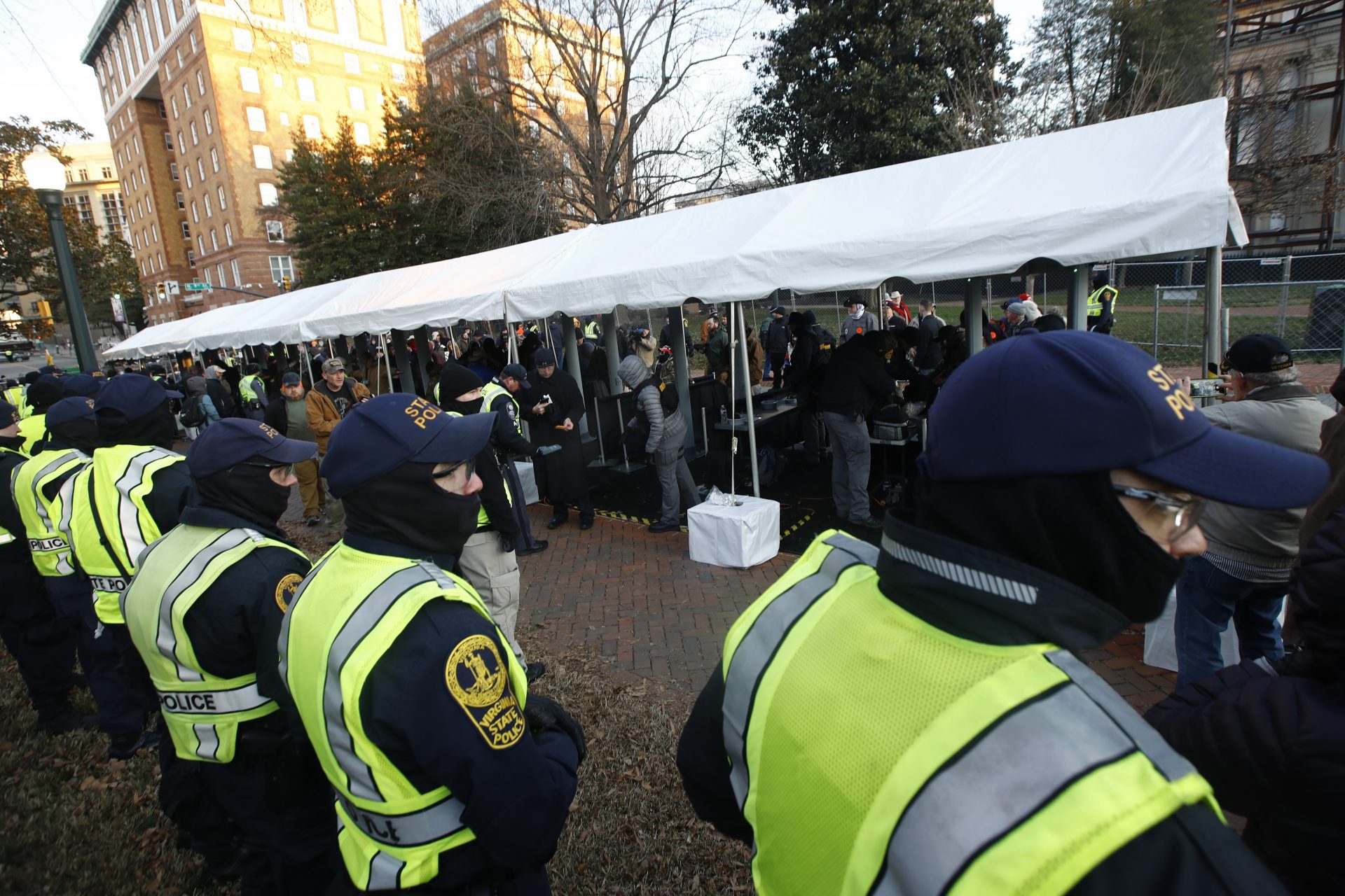 Virginia State police troopers stand near a security checkpoint before demonstrators enter the capitol grounds ahead of a pro gun rally, Monday, Jan. 20, 2020, in Richmond, Va.