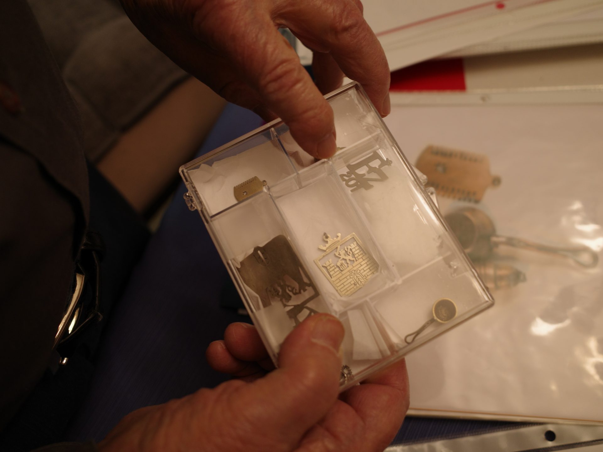 Vladimir Munk has saved jewelry he had made inside Terezin, a concentration camp north of Prague. He says the most popular was item was Terezin's coat of arms, center, which he had made for a girl he met there named Kitty, who would later become his wife of 66 years.