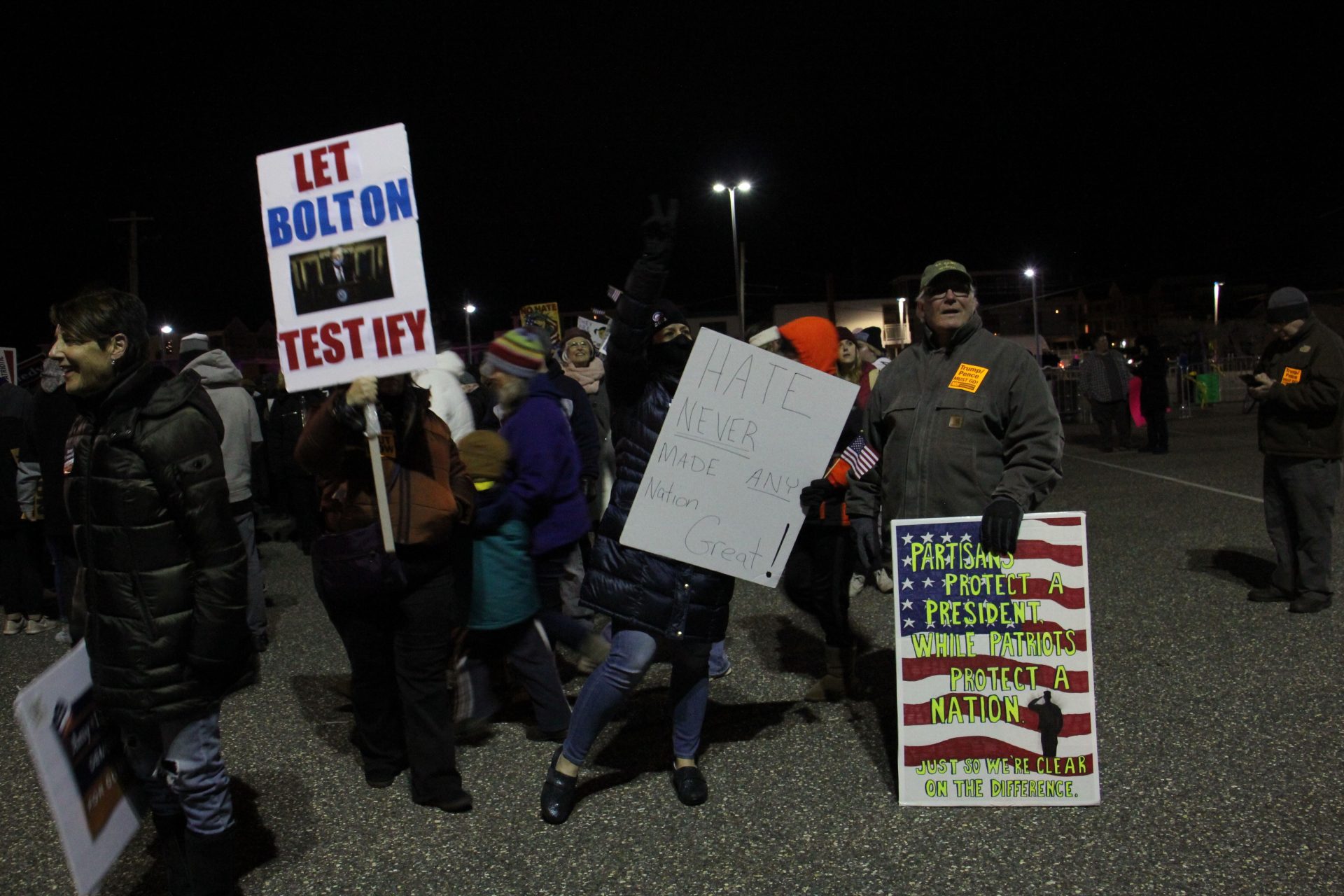 Protesters gather in a parking lot near the Wildwoods Convention Center, where President Trump was holding a rally. (Emma Lee/WHYY)