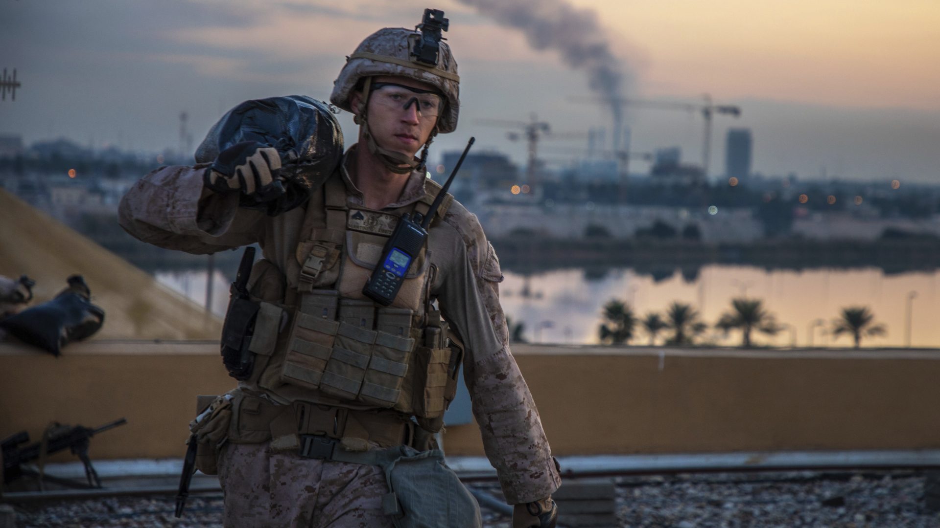 In this Saturday, Jan. 4, 2020, photo, released by the U.S. military, a U.S. Marine with 2nd Battalion, 7th Marines that is part of a quick reaction force, carries a sand bag during the reinforcement of the U.S. embassy compound in Baghdad, Iraq. The blowback over the U.S. killing of a top Iranian general mounted Sunday, Jan. 5 as Iraq's Parliament called for the expulsion of American troops from the country â€” a move that could allow a resurgence of the Islamic State group.