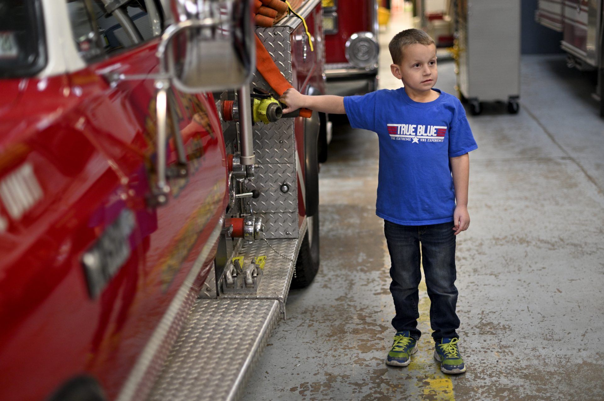 Tyler Donnatti, 6, son of the local Fire Chief, stands next to the brush truck of Rainbow Hose Co., in Schuylkill Haven, PA, on December 15, 2019.