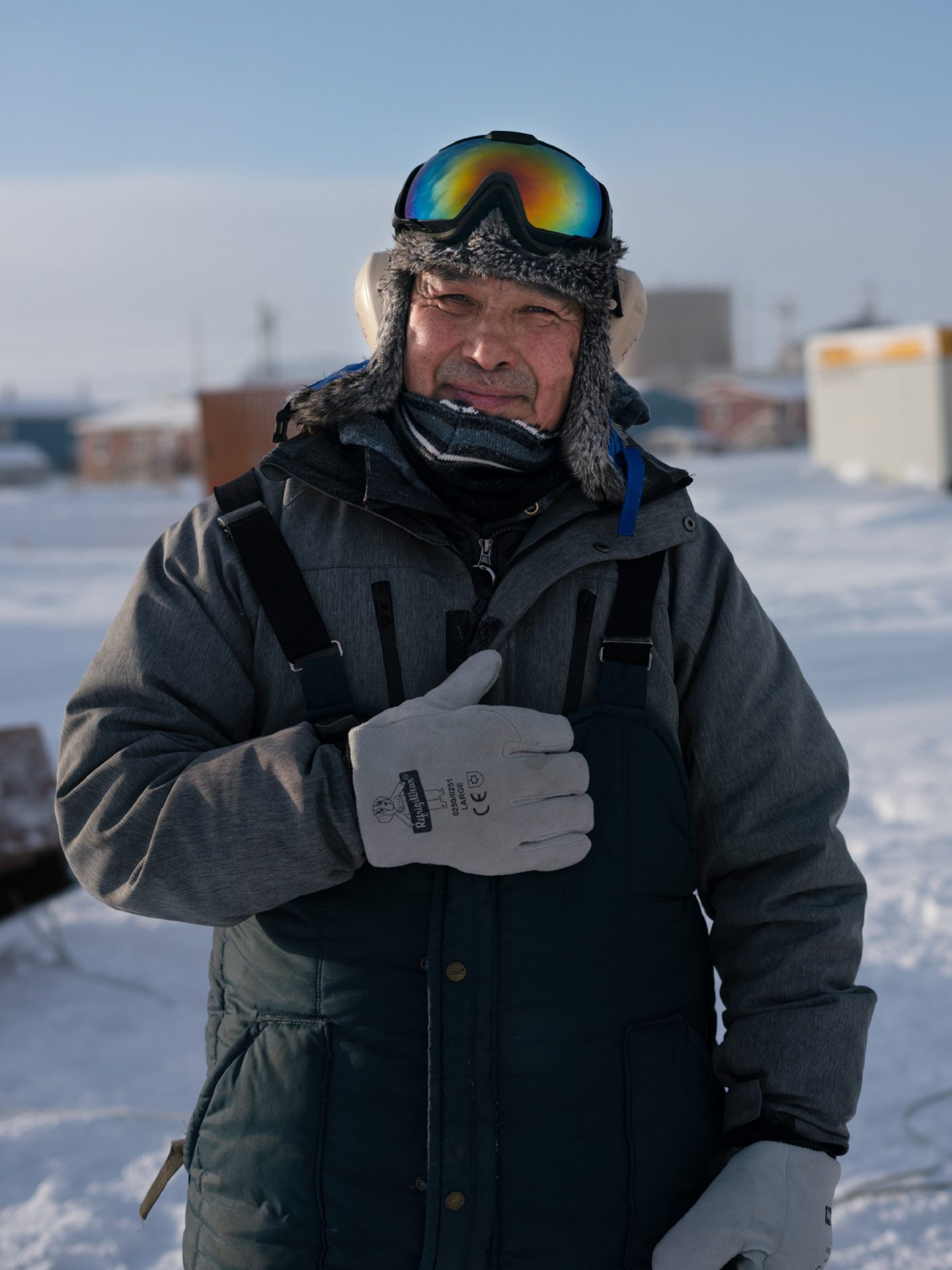 Tribal Administrator Robert Pitka stands outside in Toksook Bay in January preparing to ride a snow machine (known in the Lower 48 as a snowmobile) to neighboring Nightmute. There are no paved roads between the two villages.