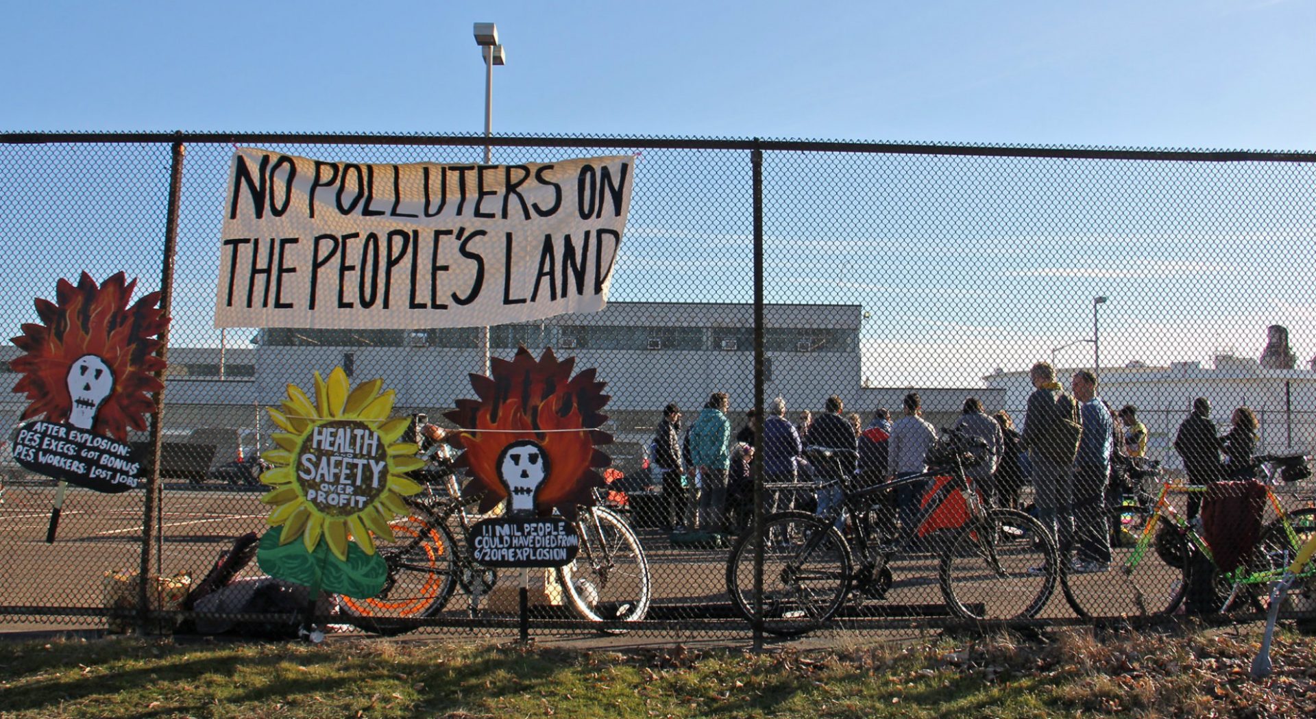 Protesters gather in a parking lot at the Philadelphia Energy Solutions refinery office on Passyunk Avenue in South Philadelphia. (Emma Lee/WHYY)