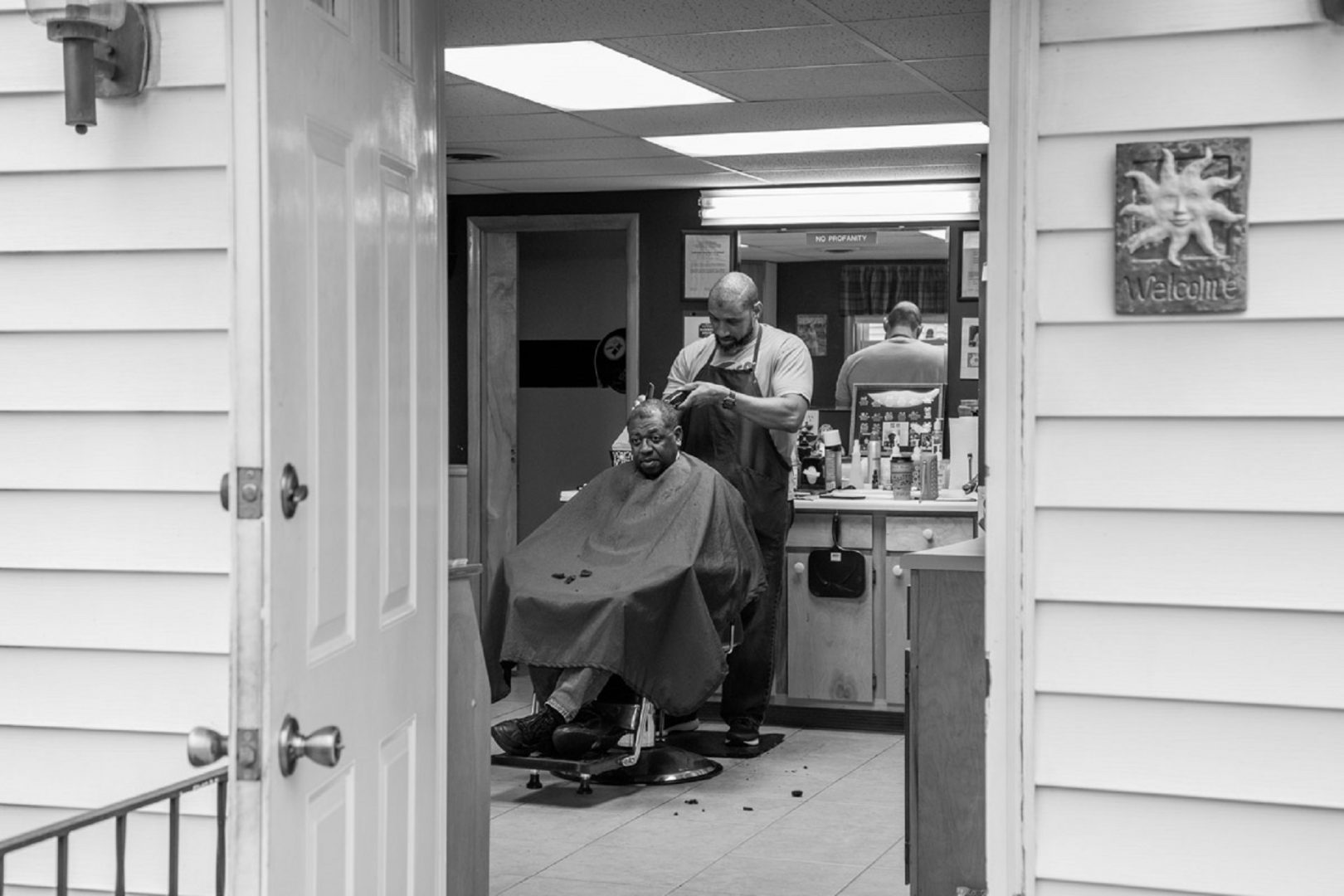 Lance Walker with a customer at his barbershop in Chambersburg, Pa.