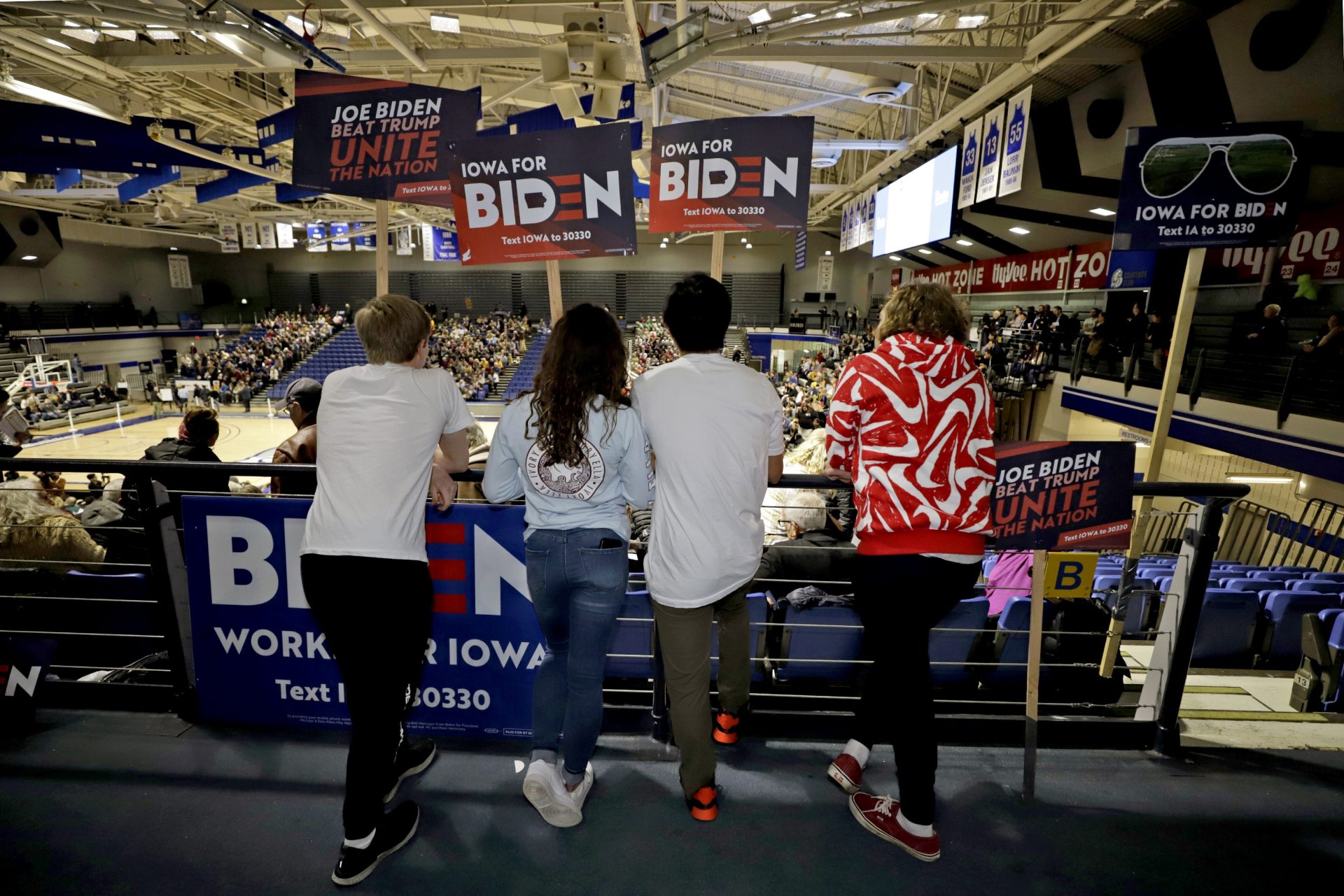 Younger caucus goers hold signs for Democratic presidential candidate former Vice President Joe Biden at the Knapp Center on the Drake University campus in Des Moines, Iowa, Monday, Feb. 3, 2020.
