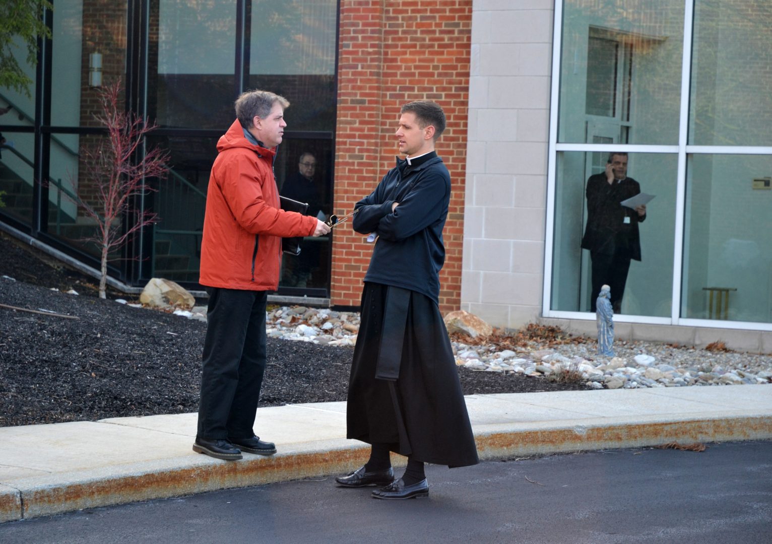 At left, the Rev. Matthew Larlick of St. Joseph’s in Berwick, Columbia County, speaks with another priest outside the Harrisburg diocese office after a meeting Wed., Feb. 19, 2020. 