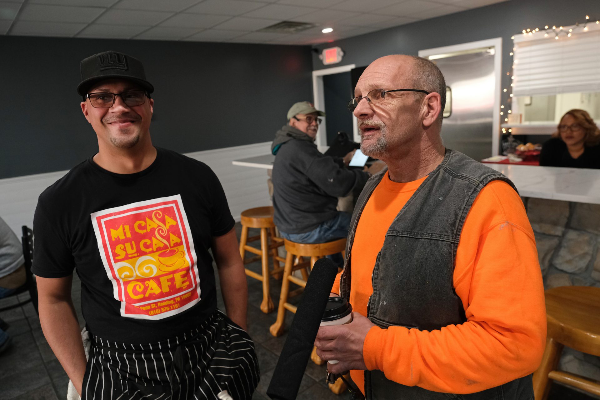 Cafe co-owner Felix Freytiz, left, talks with City of Reading employee Darrell Kauffman, right, as he stops for coffee.