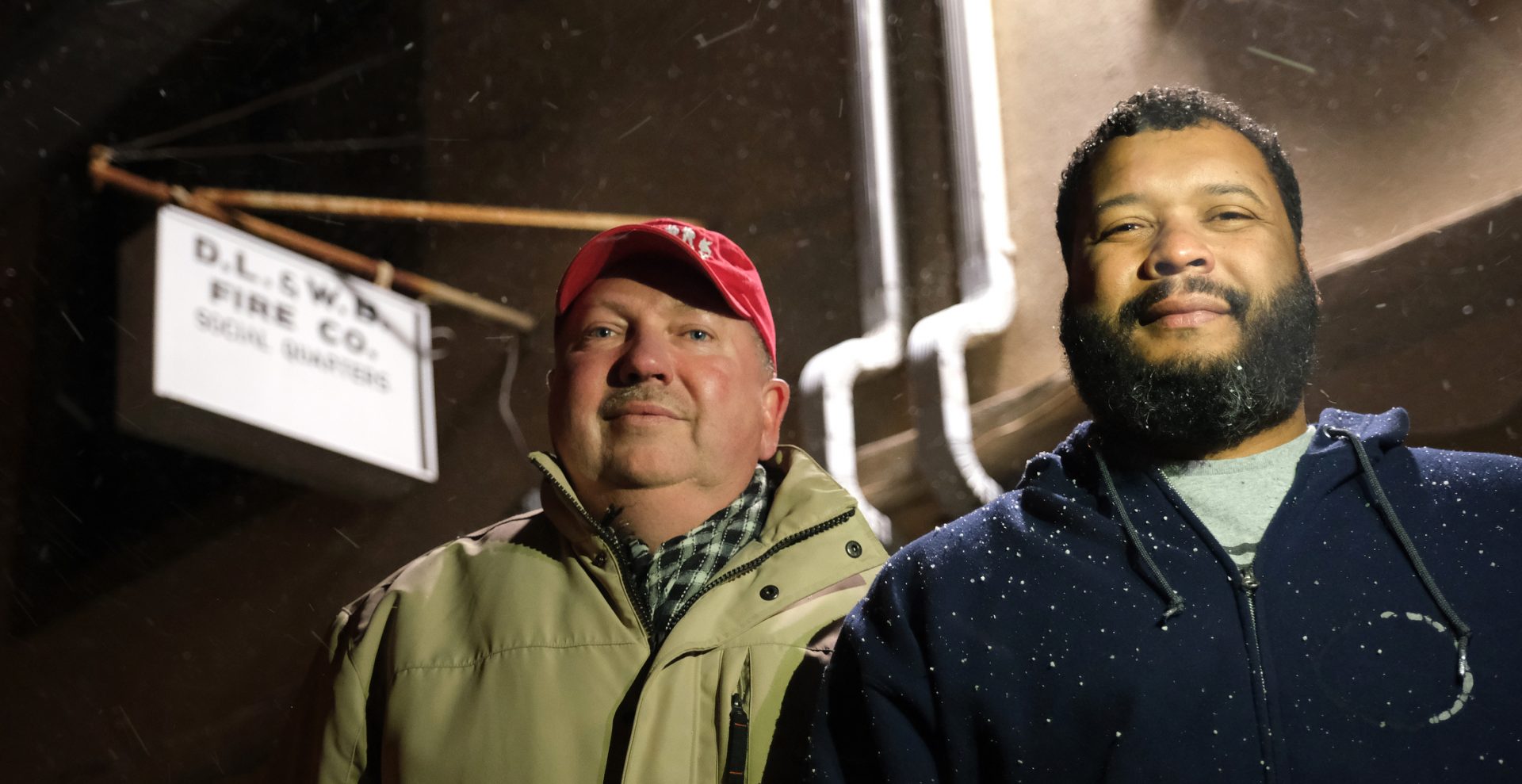 Andrew Barrow, left, and his brother Ronald Stanley Webb, Jr, nicknamed Stosh, right, stand outside Deer Lake and West Brunswick Fire Co. on Jan. 16, 2020, in Deer Lake, Pennsylvania.