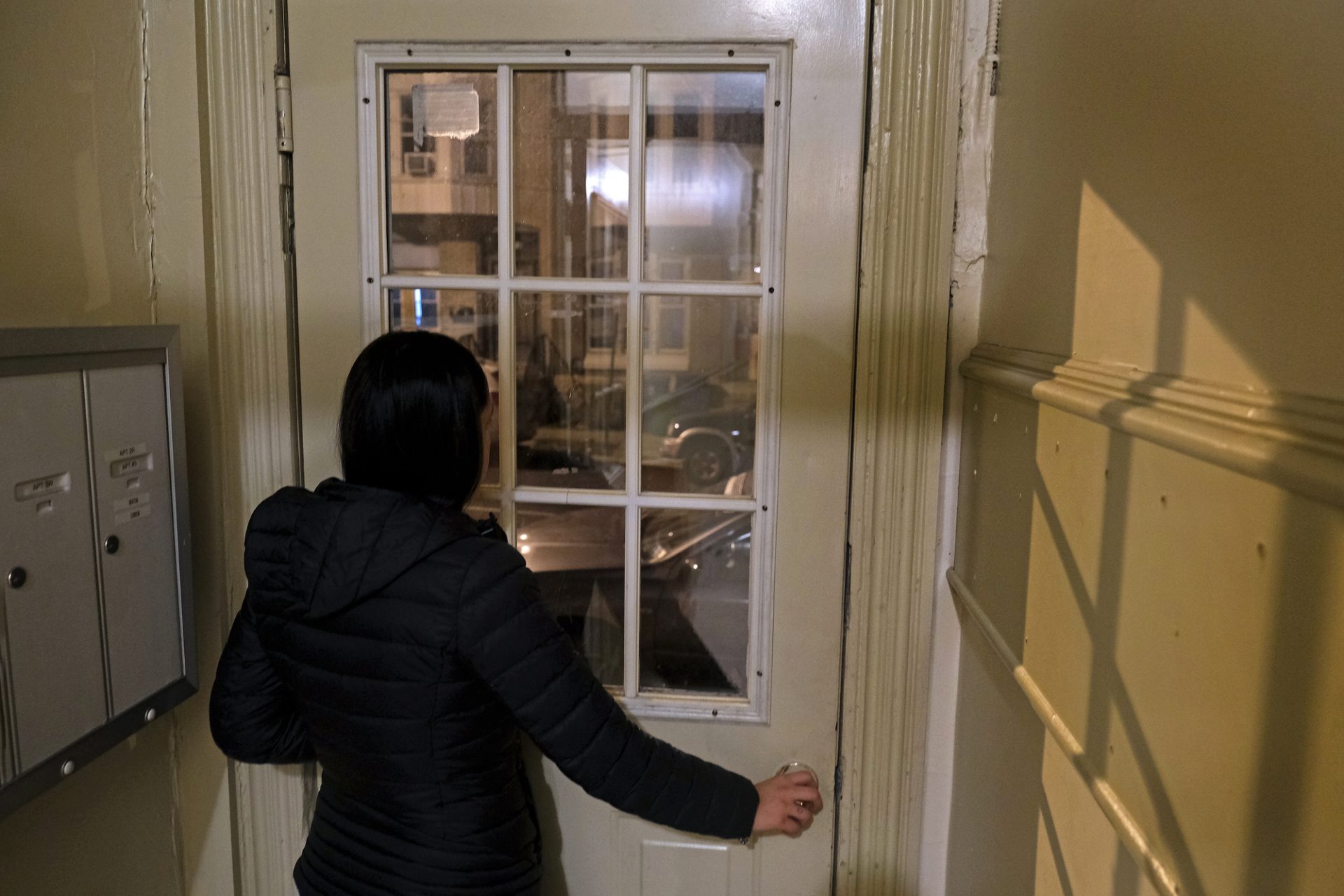 A woman who had been evicted several times stands in the doorway of her current residence Nov. 20, 2019, in Reading, Pennsylvania.