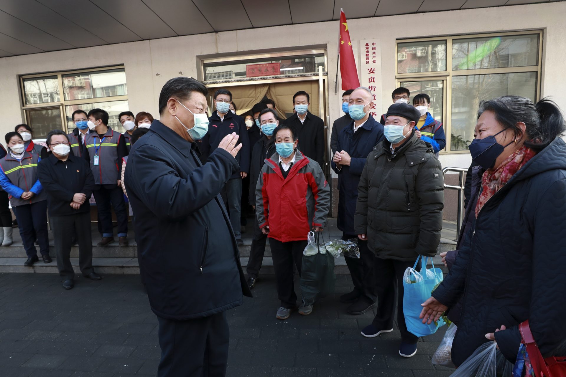 In this photo released by Xinhua News Agency, Chinese President Xi Jinping wearing a protective face mask speaks to residents as he inspects the novel coronavirus pneumonia prevention and control work at a neighbourhoods in Beijing, Monday, Feb. 10, 2020. China reported a rise in new virus cases on Monday, possibly denting optimism that its disease control measures like isolating major cities might be working, while Japan reported dozens of new cases aboard a quarantined cruise ship.