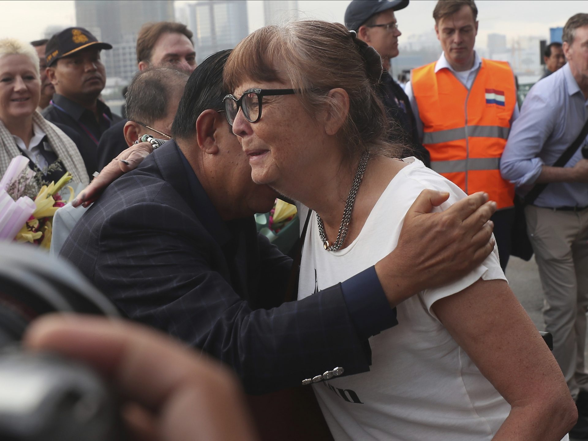 A passenger, right, is hugged by Cambodia Prime Minister Hun Sen after she disembarked from the MS Westerdam, at the port of Sihanoukville, Cambodia, on Friday.