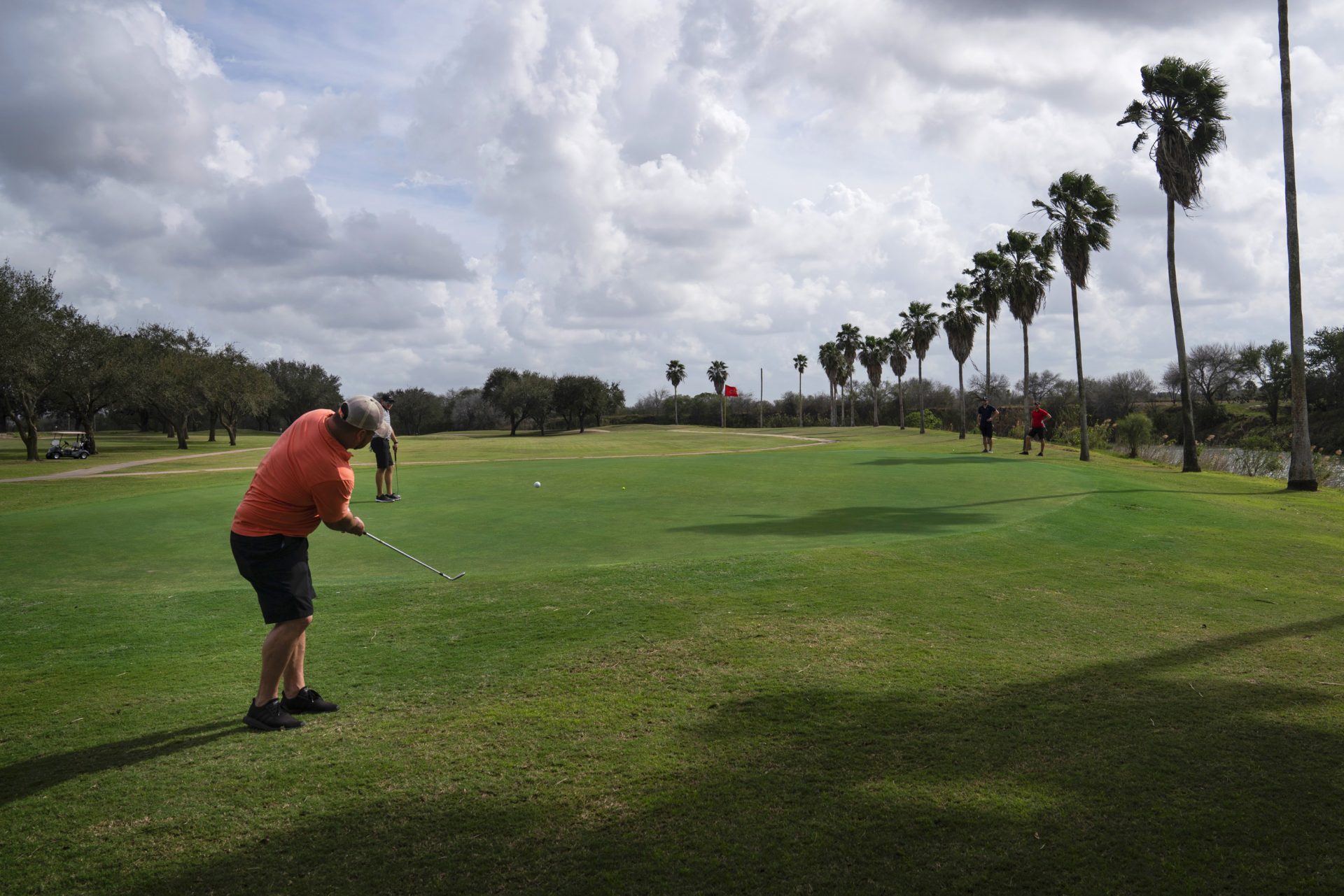 Memo Ibarra hits the ball at River Bend Resort & Golf Club in Brownsville, Texas. The 18-hole golf course would have 15 of them on the south side of Trump's proposed border wall.