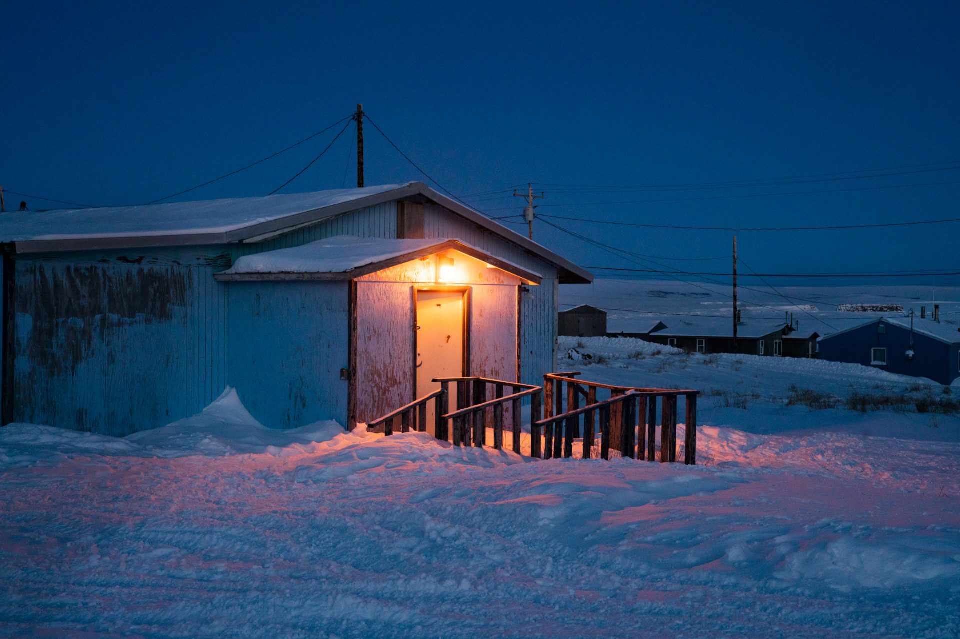 A home with the front light on in Toksook Bay.