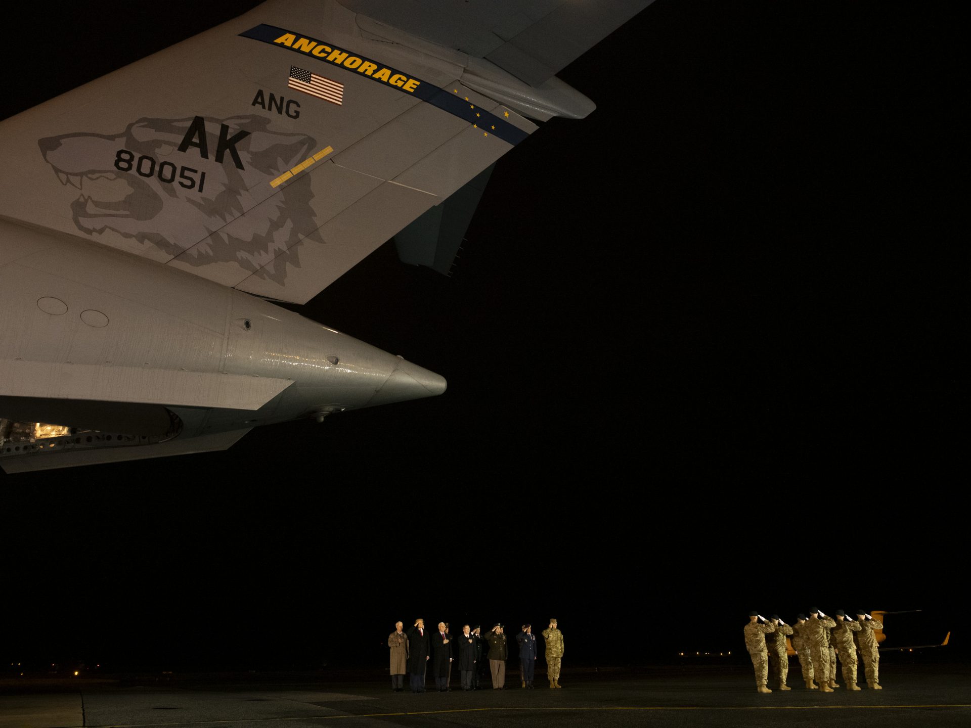 President Trump and military personnel salute during a dignified transfer ceremony at Dover Air Force Base for fallen U.S. Army sergeants Javier J. Gutierrez and Antonio R. Rodriguez.